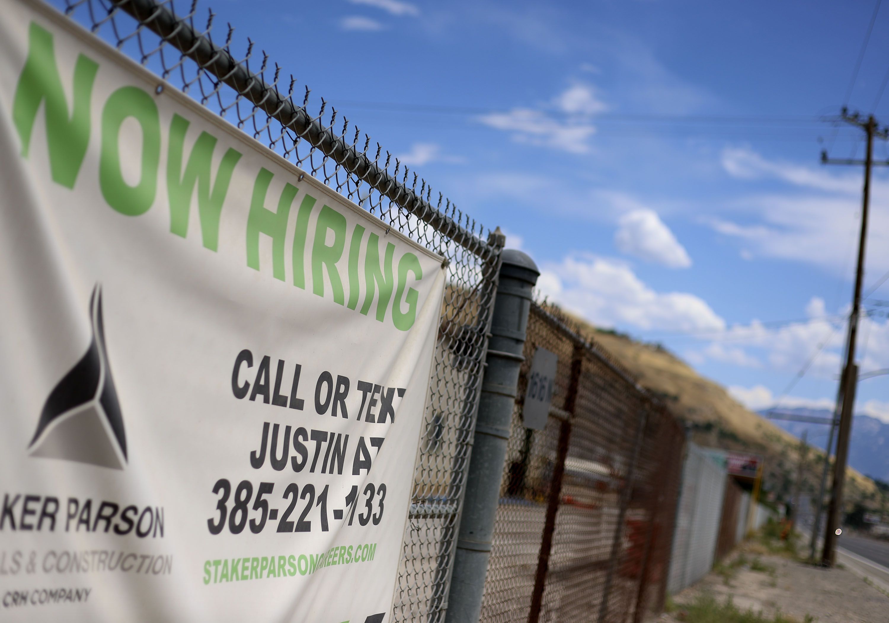 A “Now Hiring” sign is pictured outside Staker Parson in Salt Lake City on July 13. A new federal report released Friday finds employment growth is still outpacing expectations.