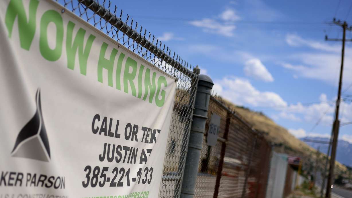 A “Now Hiring” sign is pictured outside Staker Parson in Salt Lake City on July 13. A new federal report released Friday finds employment growth is still outpacing expectations.