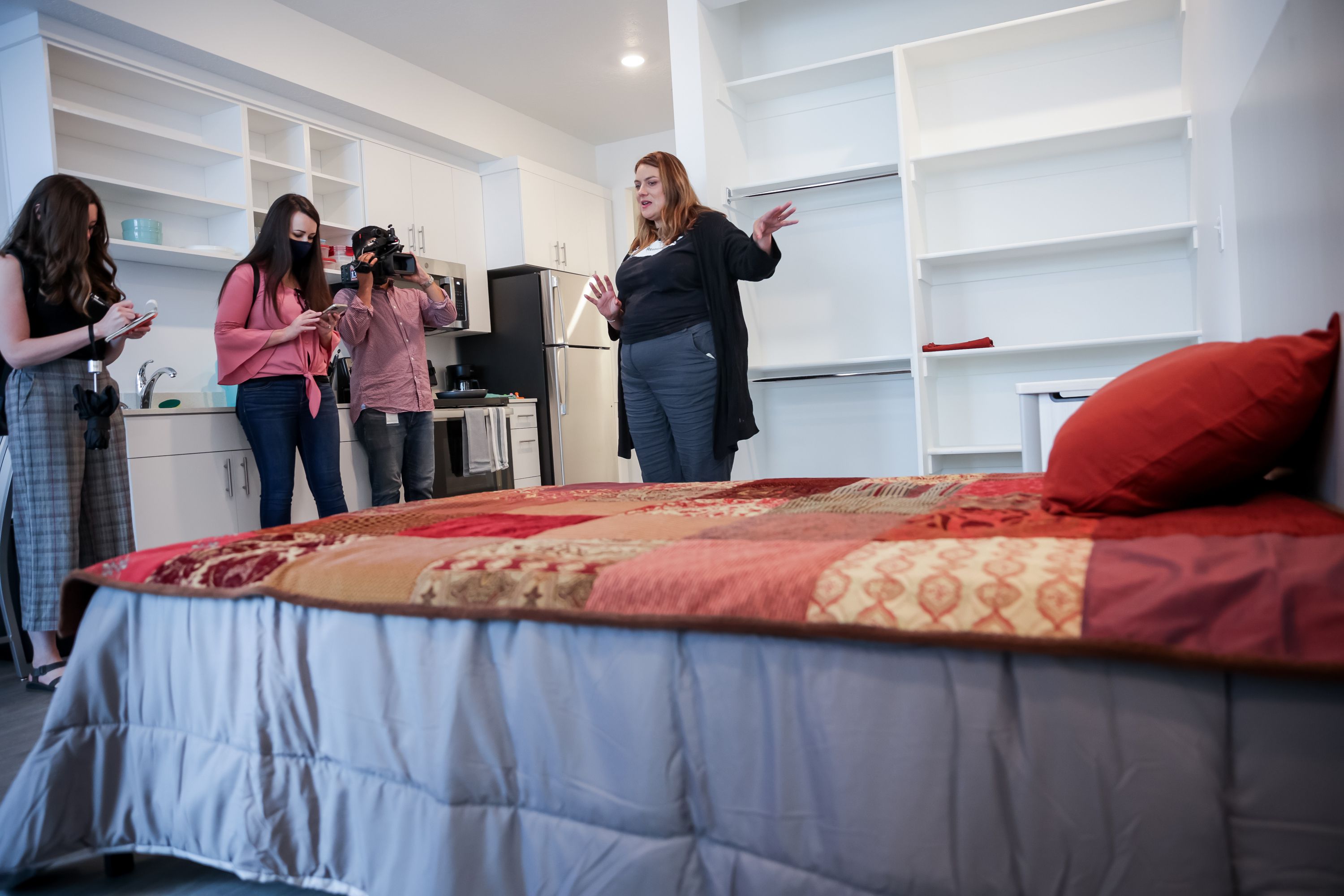 Michelle Flynn, executive director of The Road Home, right, gives a tour of Magnolia, a new permanent supportive housing building, during its opening celebration in Salt Lake City on June 24, 2021.