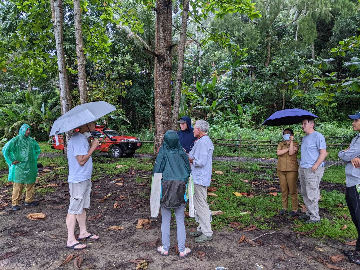 A team of BYU students and Indonesian locals discuss methods for data collection to help with their risk reduction strategies for natural disasters.