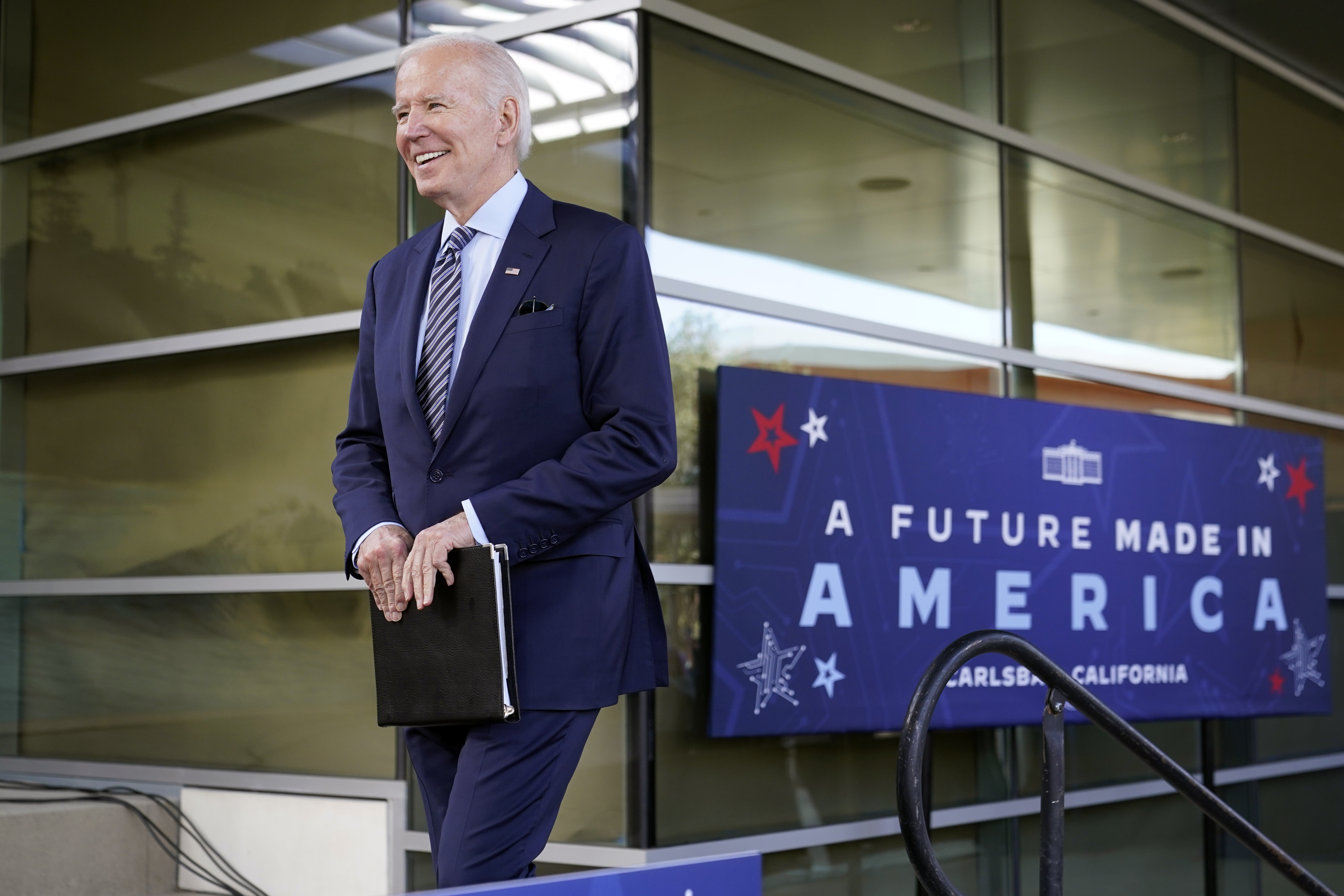 President Joe Biden smiles as he walks onto stage after being introduced to speak about the CHIPS and Science Act, a measure intended to boost the semiconductor industry and scientific research, at ViaSat, Friday in Carlsbad, Calif. 