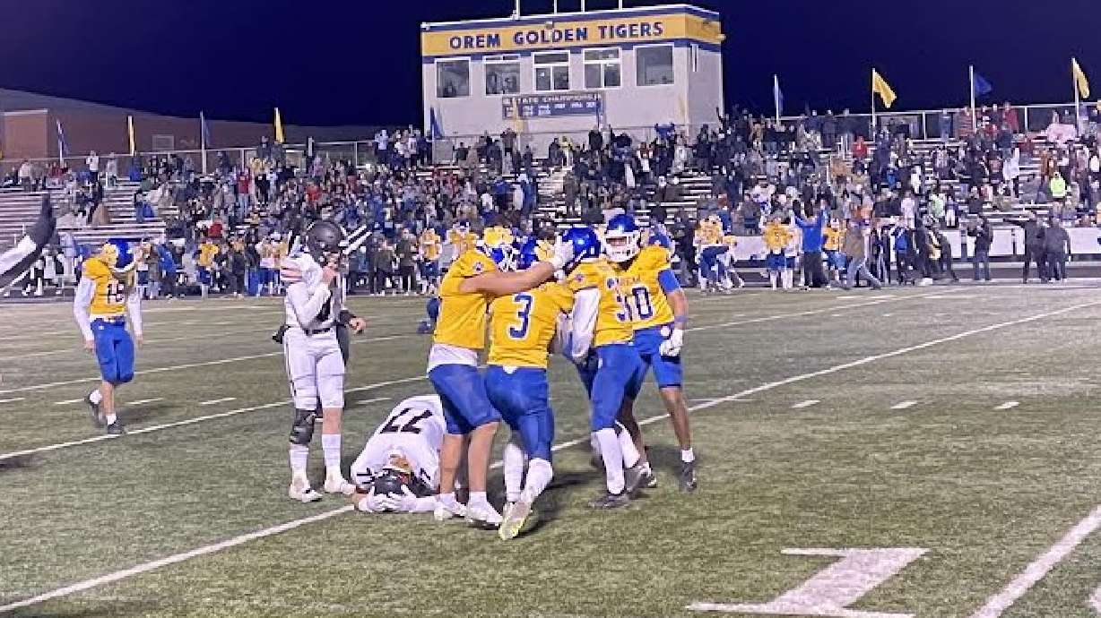 Orem players celebrate after a game-winning field-goal attempt is blocked against Alta.