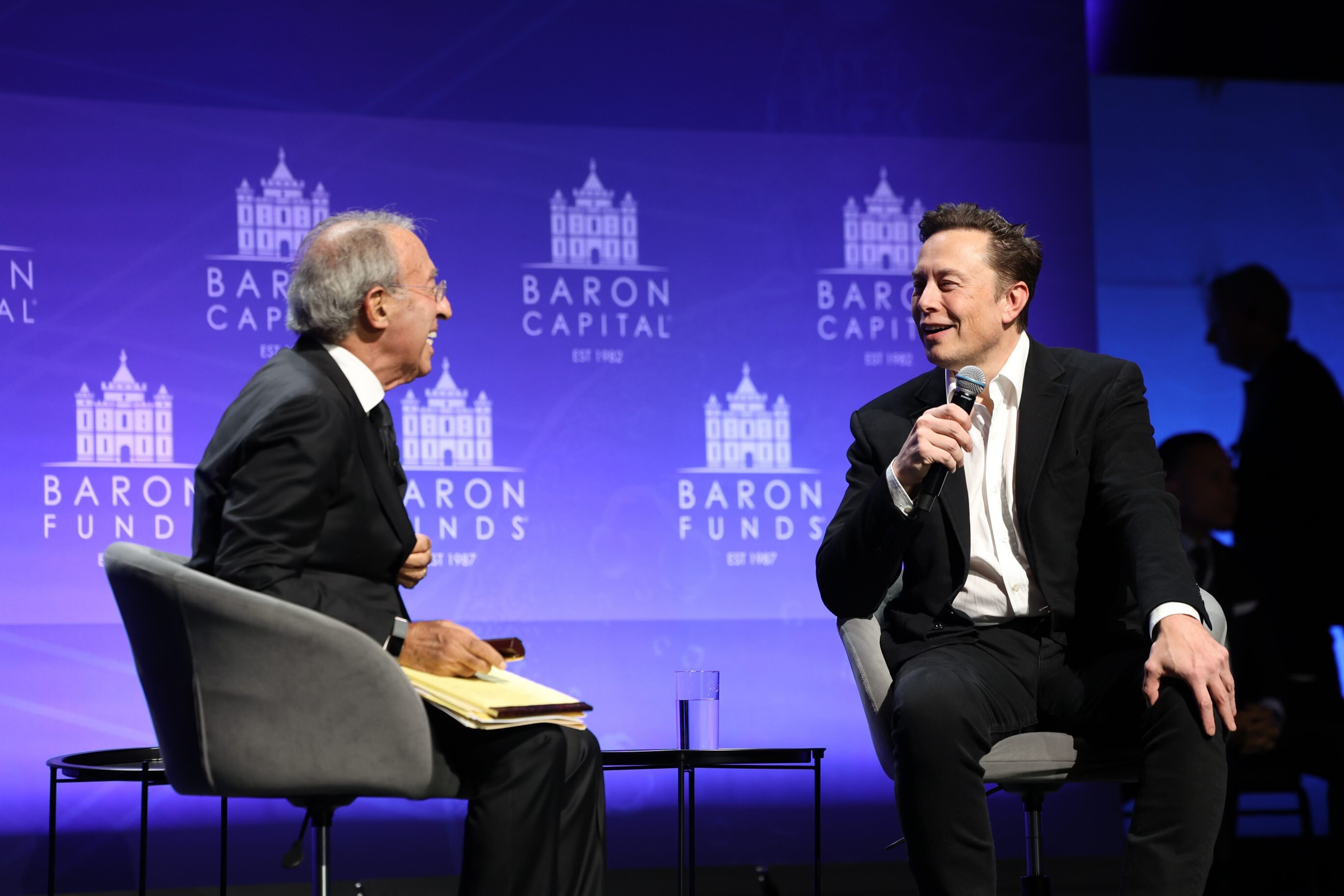 Baron Capital Group Chairman Ron Baron interviews new Twitter owner Elon Musk in New York City on Friday. Twitter on Saturday launched a subscription service for $7.99 a month that includes a blue check now given only to verified accounts as Musk overhauls the platform's verification system 