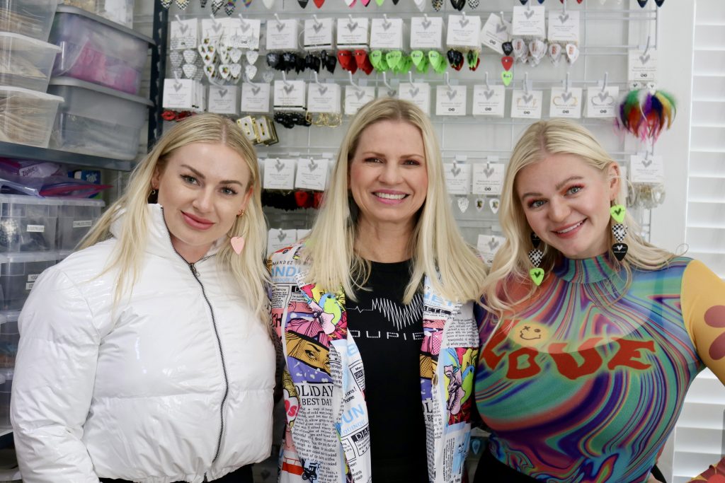Brooklyn Callahan, Mary Love and Amber Foster pose for a photo inside the Groupie Love shop, St. George on Wednesday, Oct. 26. Love's St. George business is hitting all the right notes with its wild variety of guitar pick earrings.
