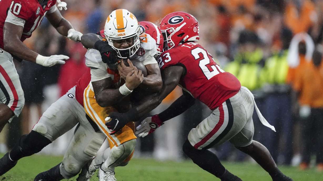 Tennessee running back Jaylen Wright (20) is stopped by Georgia defensive back Tykee Smith (23) during the second half of an NCAA college football game Saturday, Nov. 5, 2022 in Athens, Ga.