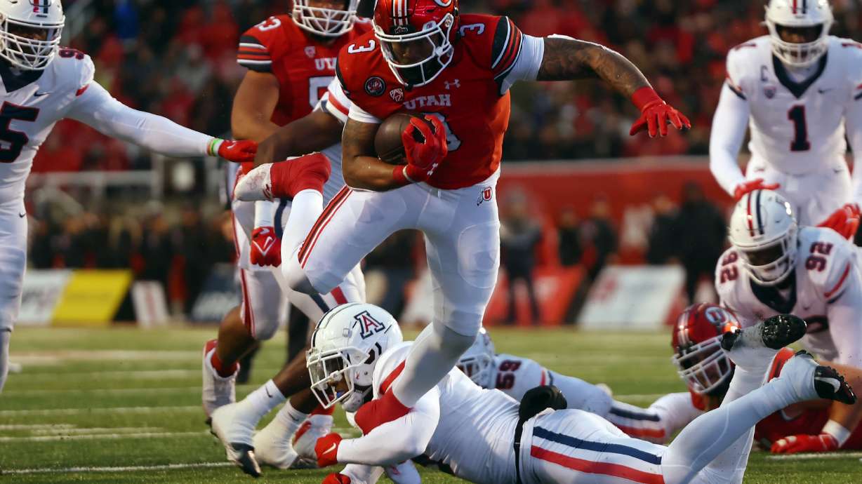 Utah Utes running back Ja'Quinden Jackson (3) is tripped up by Arizona Wildcats safety Christian Young (5) as Utah and Arizona play at Rice Eccles Stadium in Salt Lake City on Saturday, Nov. 5, 2022.