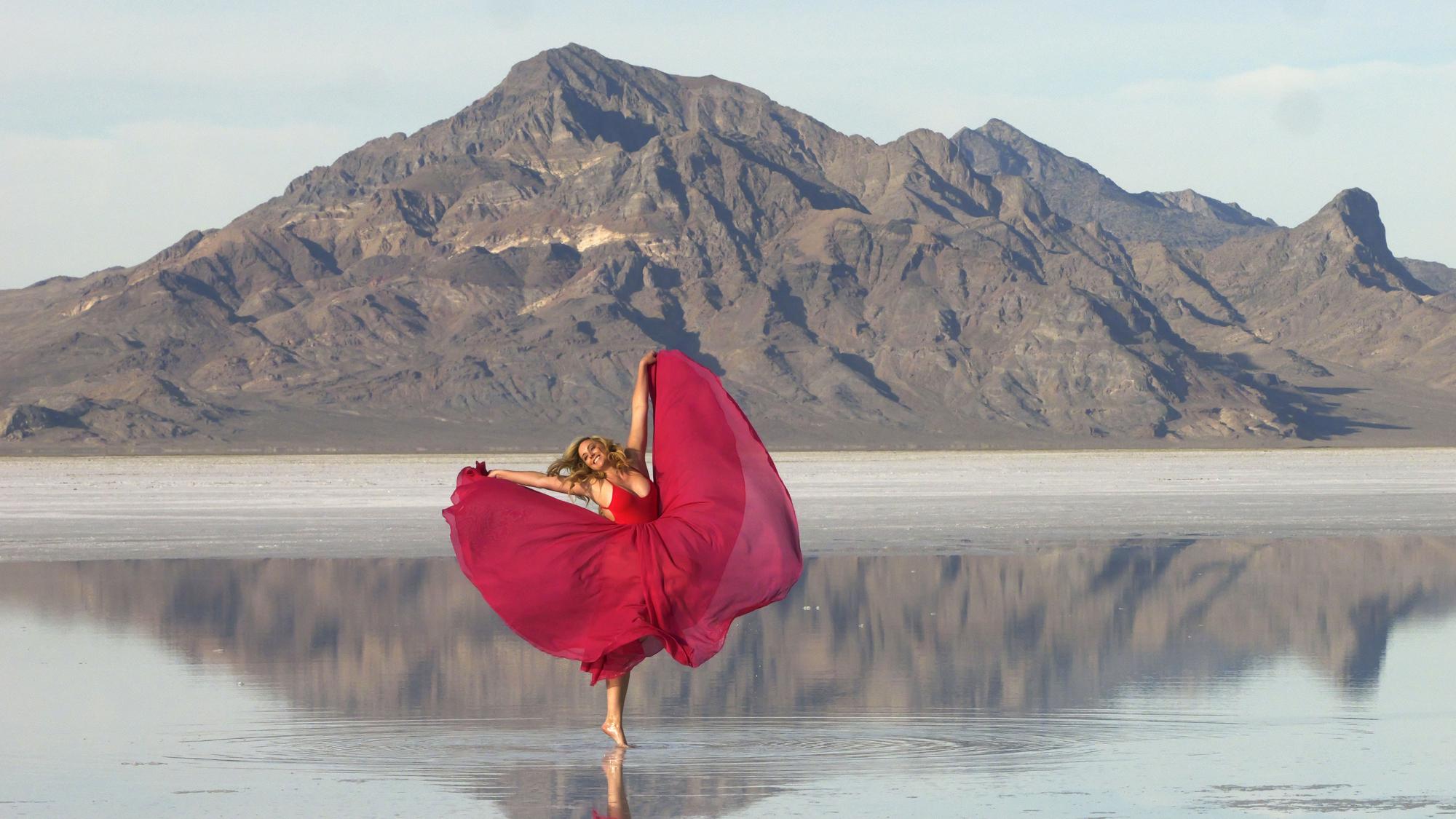 A visitor to Bonneville Salt Flats poses for photographs Oct. 8, near Wendover.