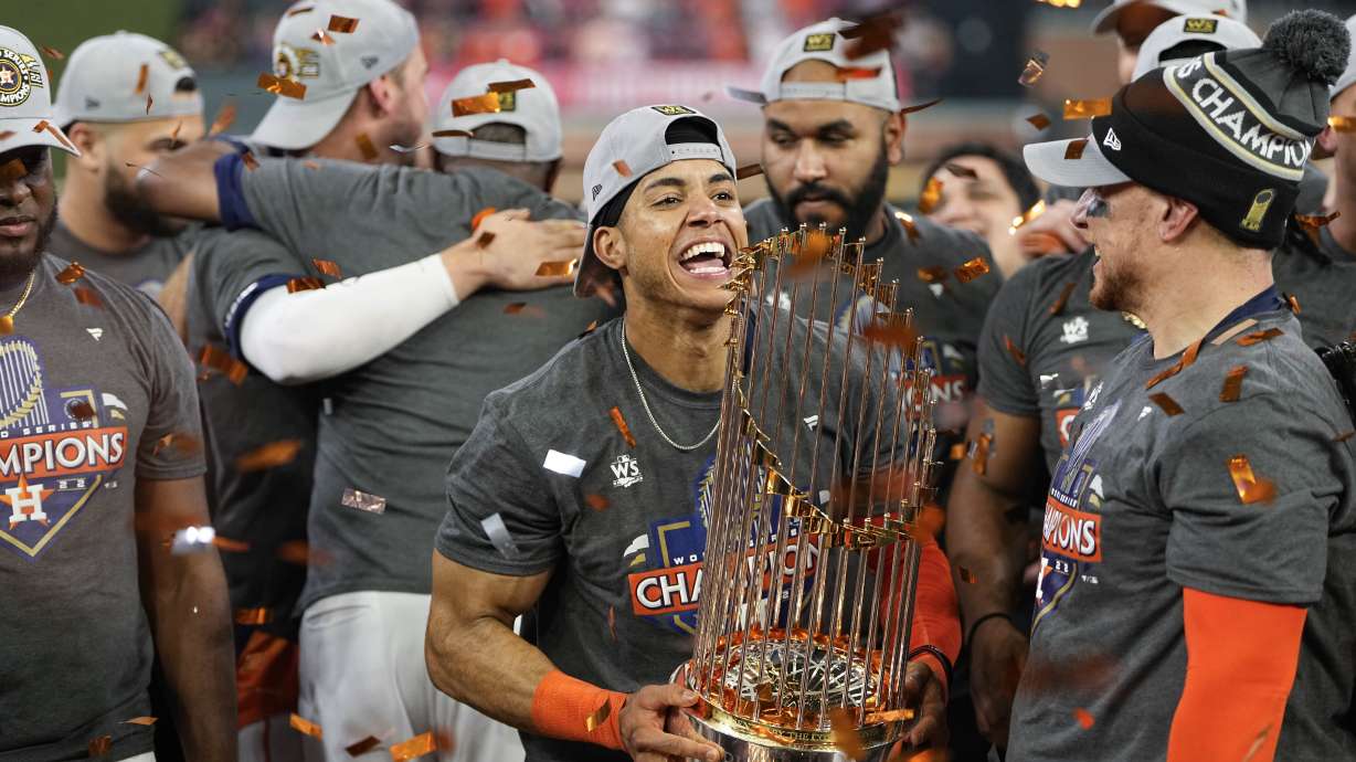 Houston Astros shortstop Jeremy Pena celebrates with the trophy after their 4-1 World Series win against the Philadelphia Phillies in Game 6 on Saturday, Nov. 5, 2022, in Houston.