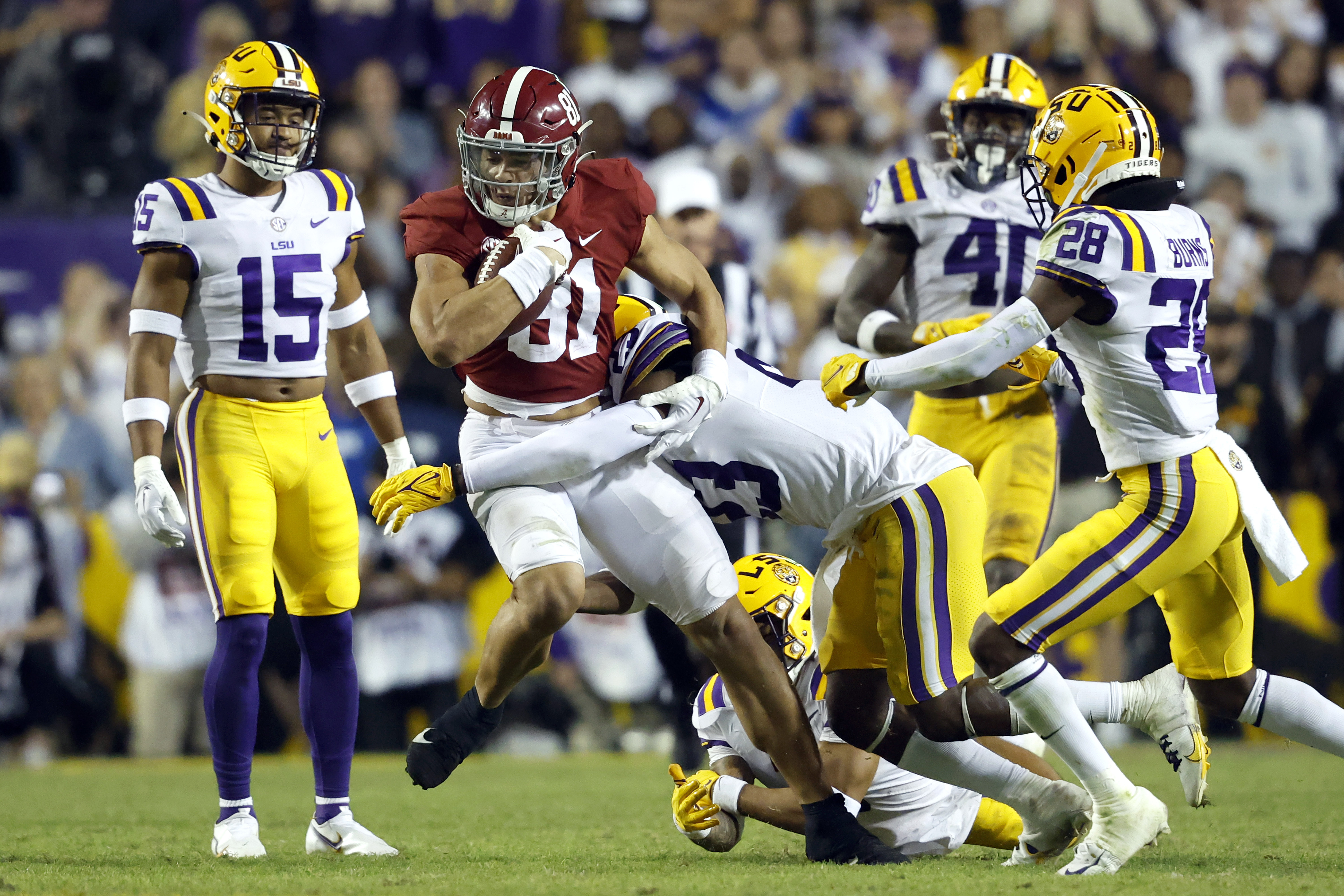 Alabama tight end Cameron Latu (81) is tackled by LSU linebacker Micah Baskerville (23) during the second half of an NCAA college football game in Baton Rouge, La., Saturday, Nov. 5, 2022. LSU won 32-31 in overtime.
