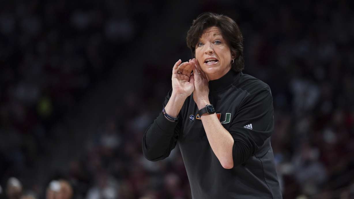 Miami head coach Katie Meier communicates with players during the first half a second-round game against South Carolina in the NCAA college basketball tournament, March 20, 2022 in Columbia, S.C. Meier will miss her team's first three games of the season while the Hurricanes and the NCAA work through an enforcement investigation.