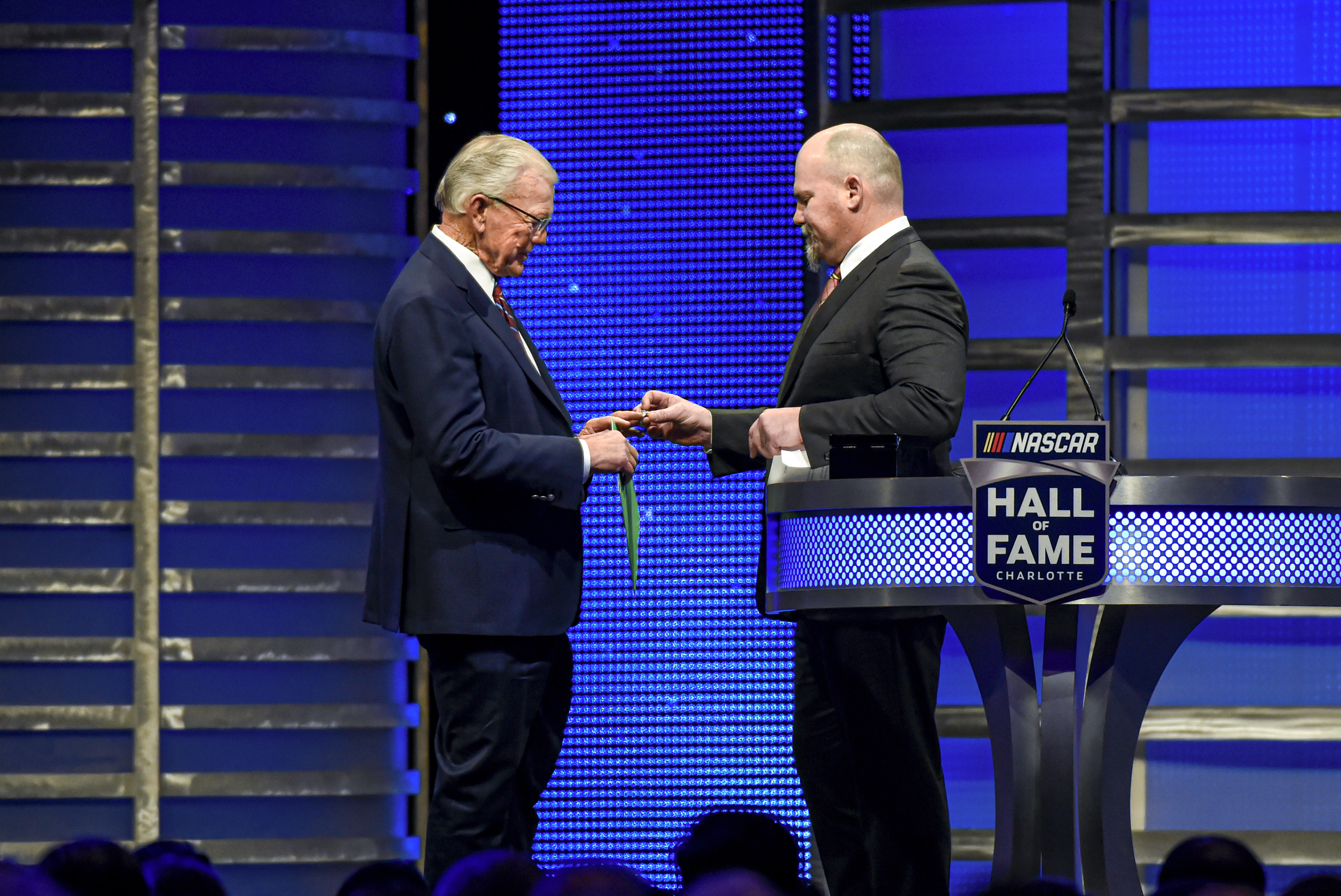 FILE - Coy Gibbs, right, presents the Hall of Fame ring to his father, NASCAR Hall of Fame inductee Joe Gibbs, during the induction ceremony in Charlotte, N.C., on Jan. 31, 2020. Coy, the vice chairman at Joe Gibbs Racing for his NFL and NASCAR Hall of Fame father, died Sunday morning, Nov. 6, 2022. He was 49. His death came just hour after his son Ty won the Xfinity Series championship. 