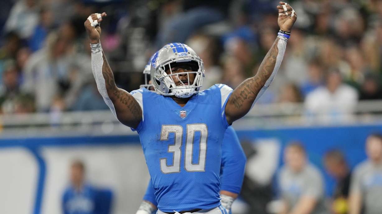 Detroit Lions running back Jamaal Williams (30) reacts after scoring on a 2-point conversion during the first half of an NFL football game against the Green Bay Packers, Sunday, Nov. 6, 2022, in Detroit.