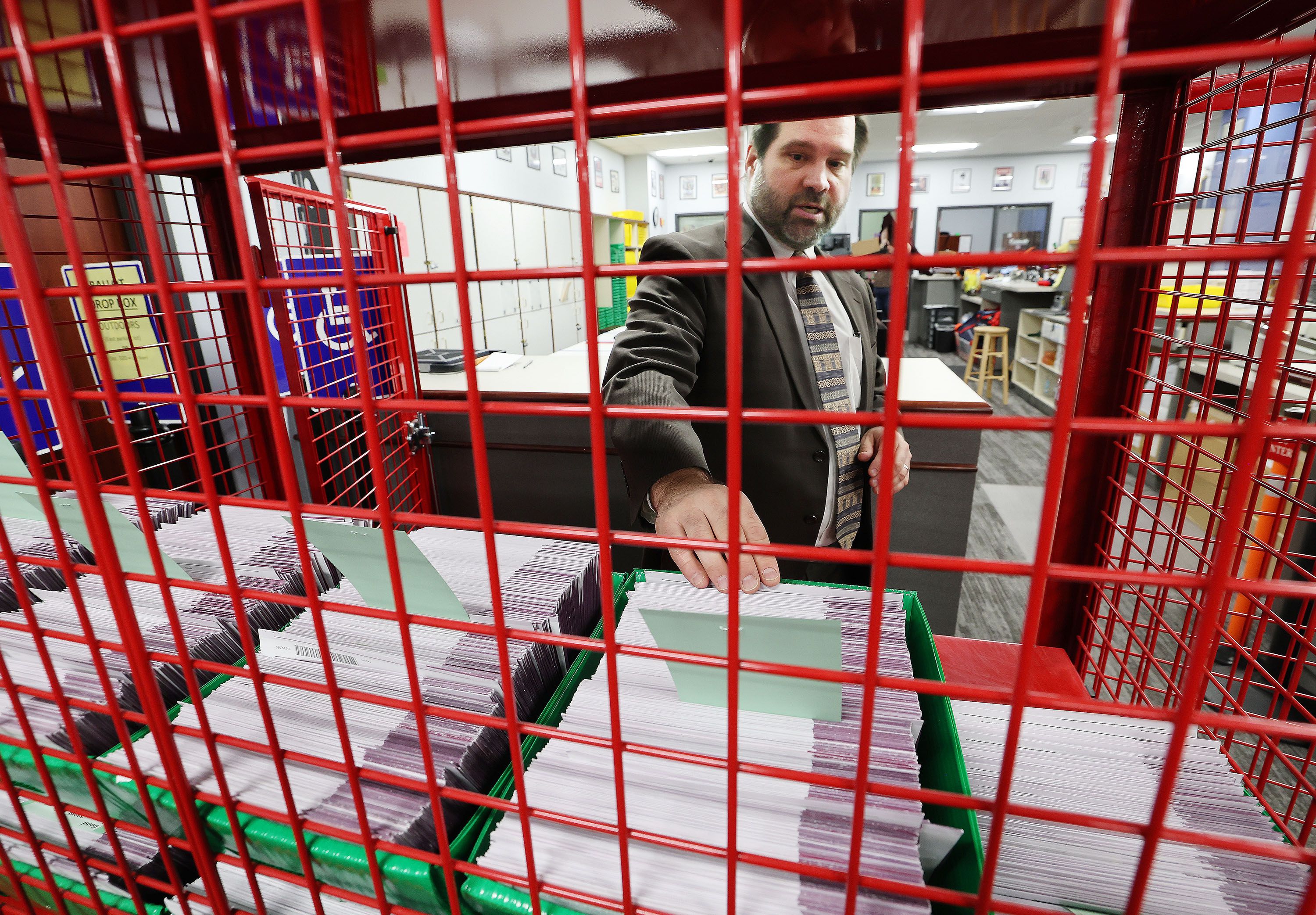 Ricky Hatch, Weber County Clerk, looks over ballots that have been cast in Ogden on Wednesday, Oct. 26, 2022.