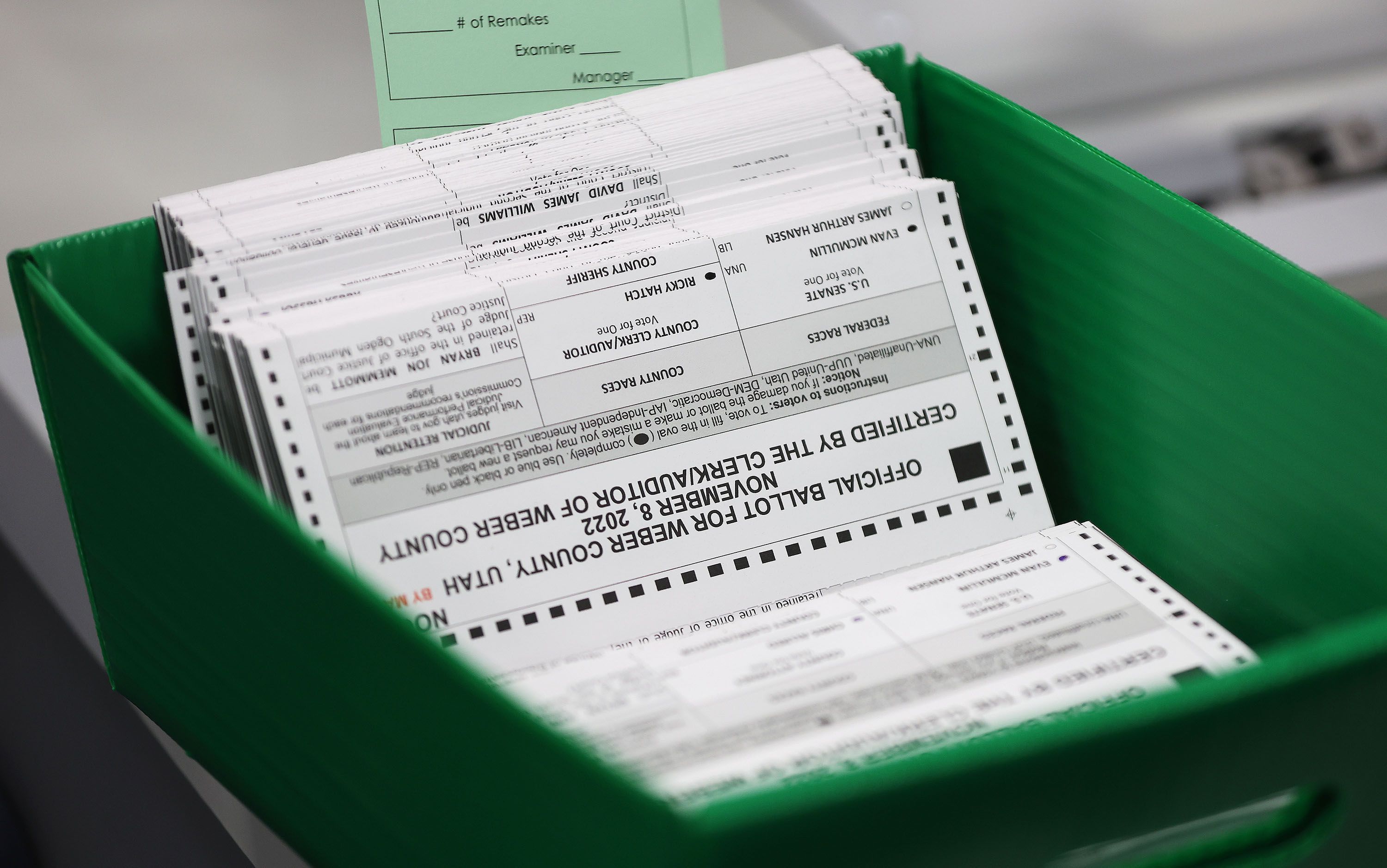 Casted ballots are extracted from the envelope in Ogden on Wednesday, Oct. 26, 2022.
