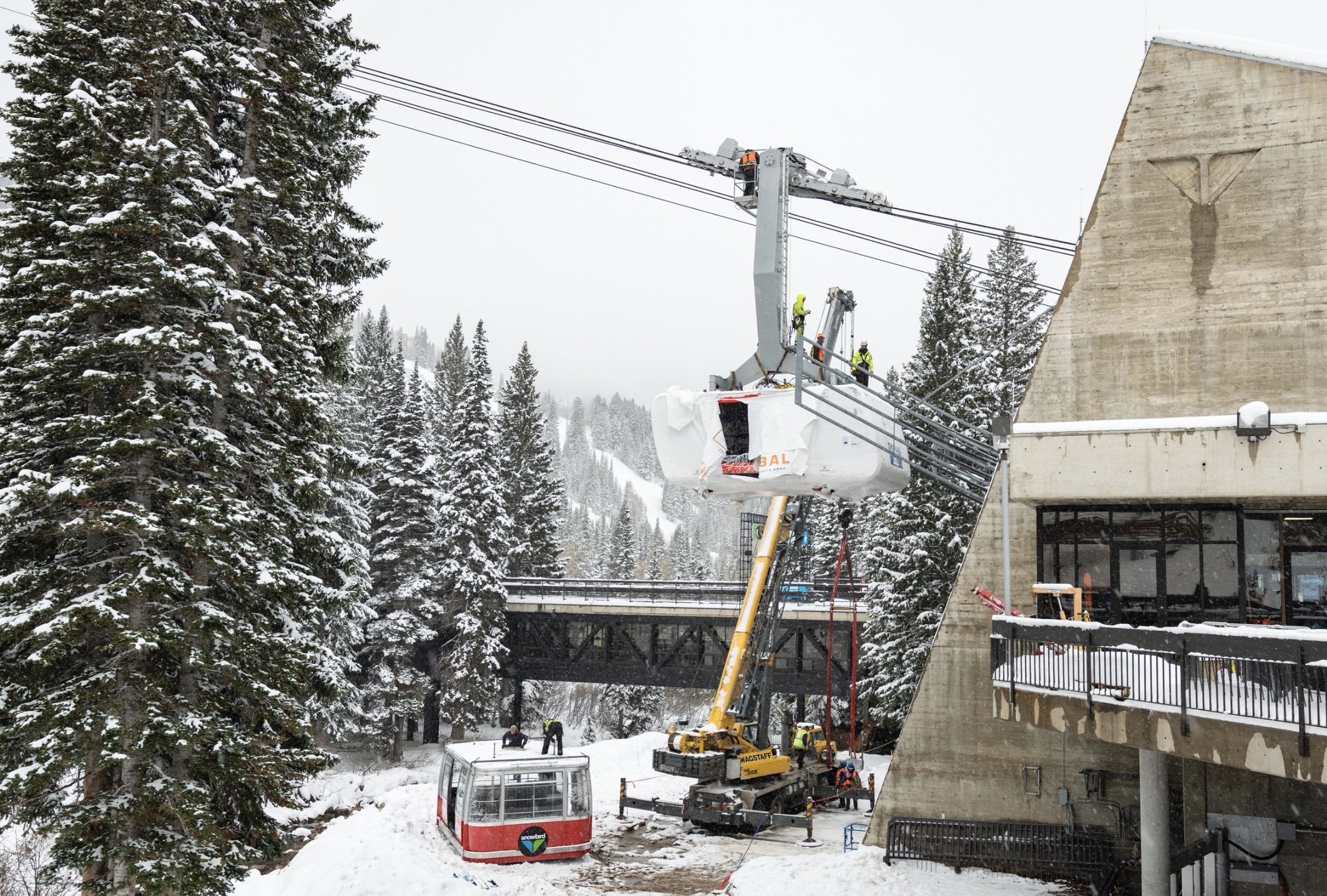 Crews install a new Doppelmayr cabin to Snowbird's tram cable on Saturday. The previous new cabin was destroyed in an installation mishap in May.