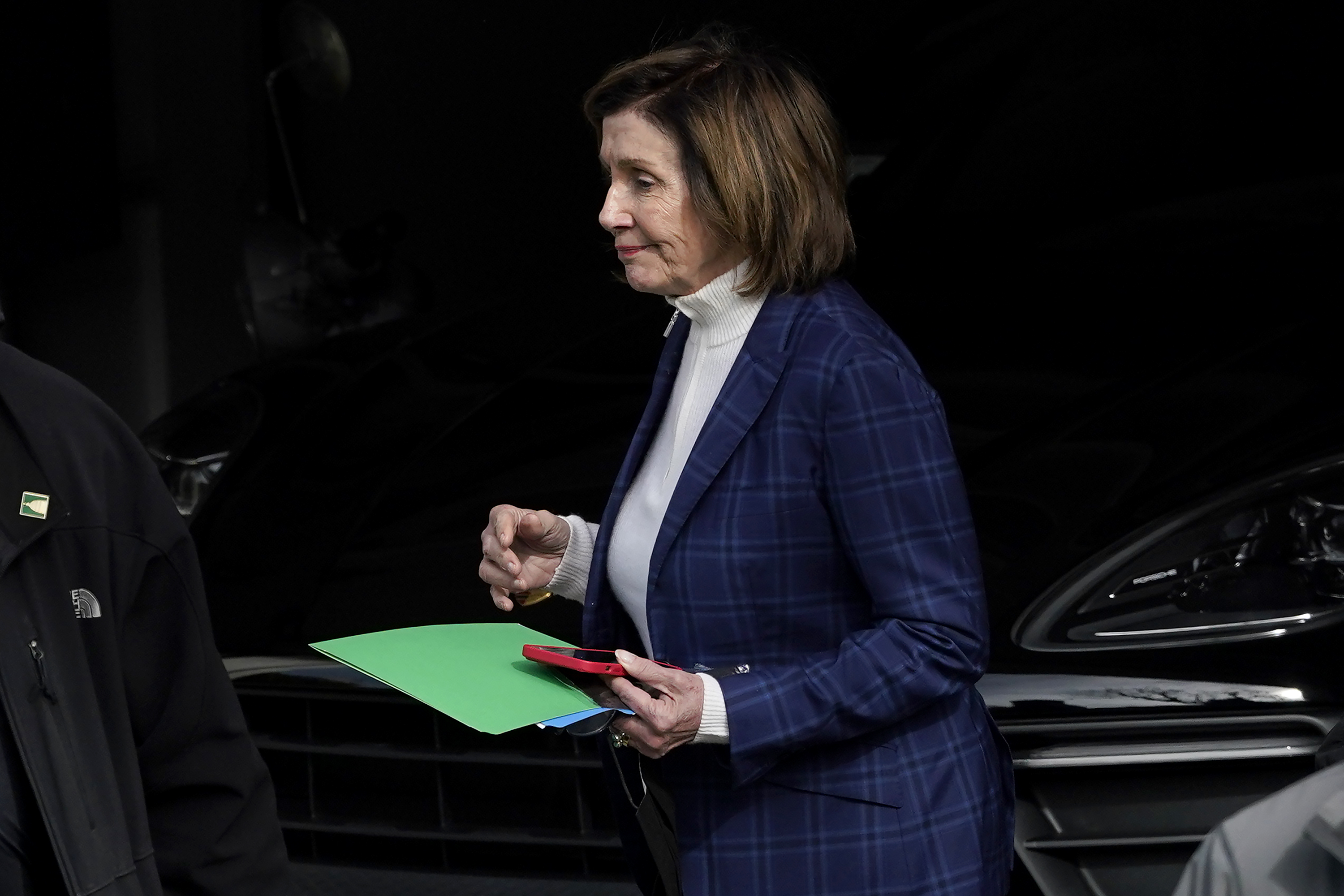 House Speaker Nancy Pelosi is escorted to a vehicle outside of her home in San Francisco on Nov. 4.