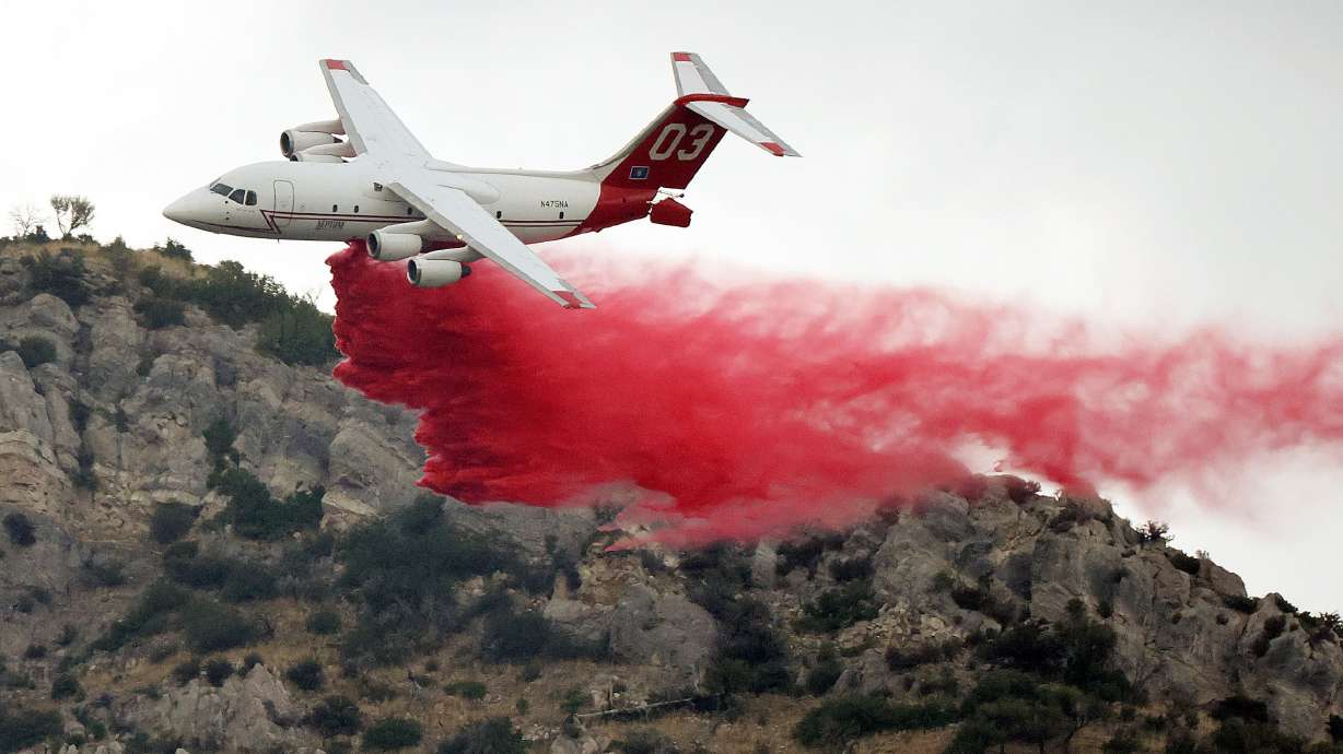 A plane drops fire retardant on a wildfire in Springville on Aug. 1. Drought, wildfire, flooding, record-breaking heat, dismal snowpack and even extreme flash floods are some of the extreme weather events that will be discussed at the 2022 United Nations Climate Change Conference in Egypt this month.