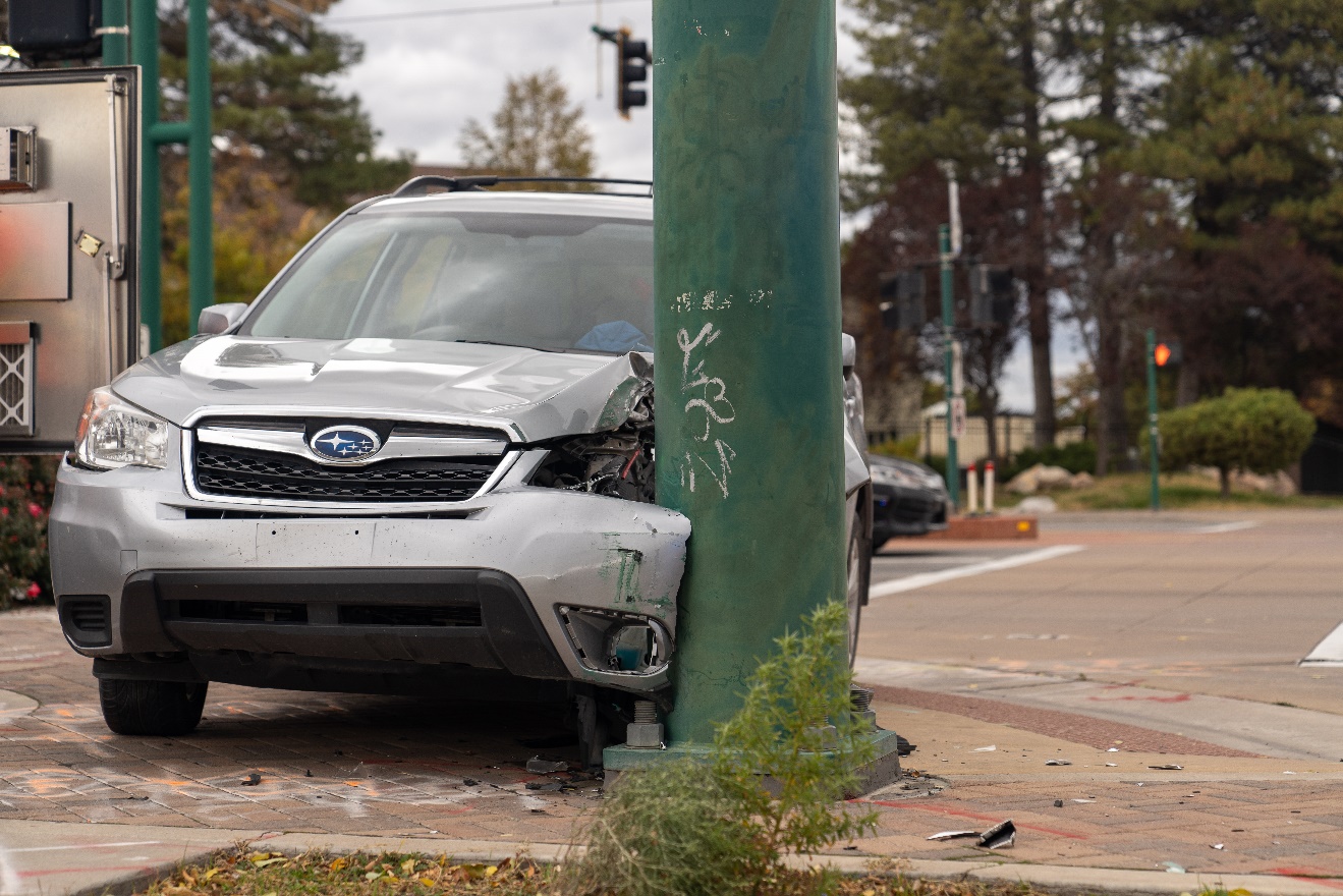 Police say a man has been arrested after crashing a stolen SUV into a traffic pole, and then running from officers Monday morning. 