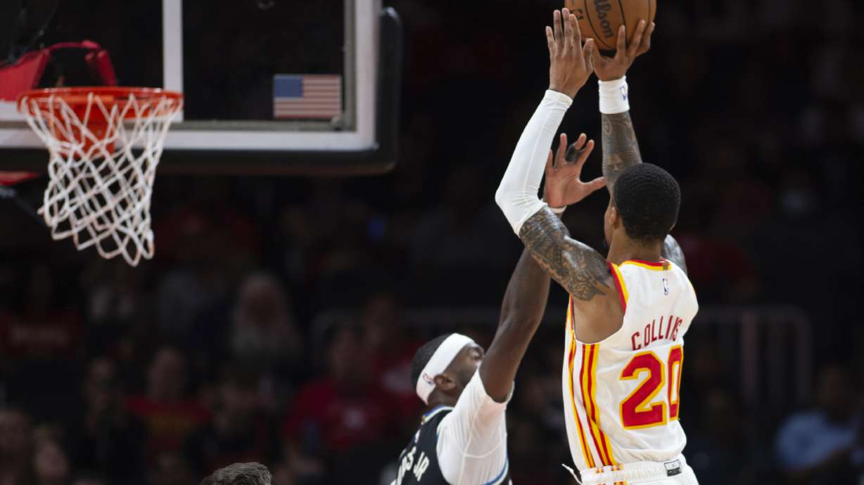 Atlanta Hawks' John Collins shoots over Milwaukee Bucks' Bobby Portis Jr. during the first half of an NBA basketball game Monday, Nov. 7, 2022, in Atlanta.