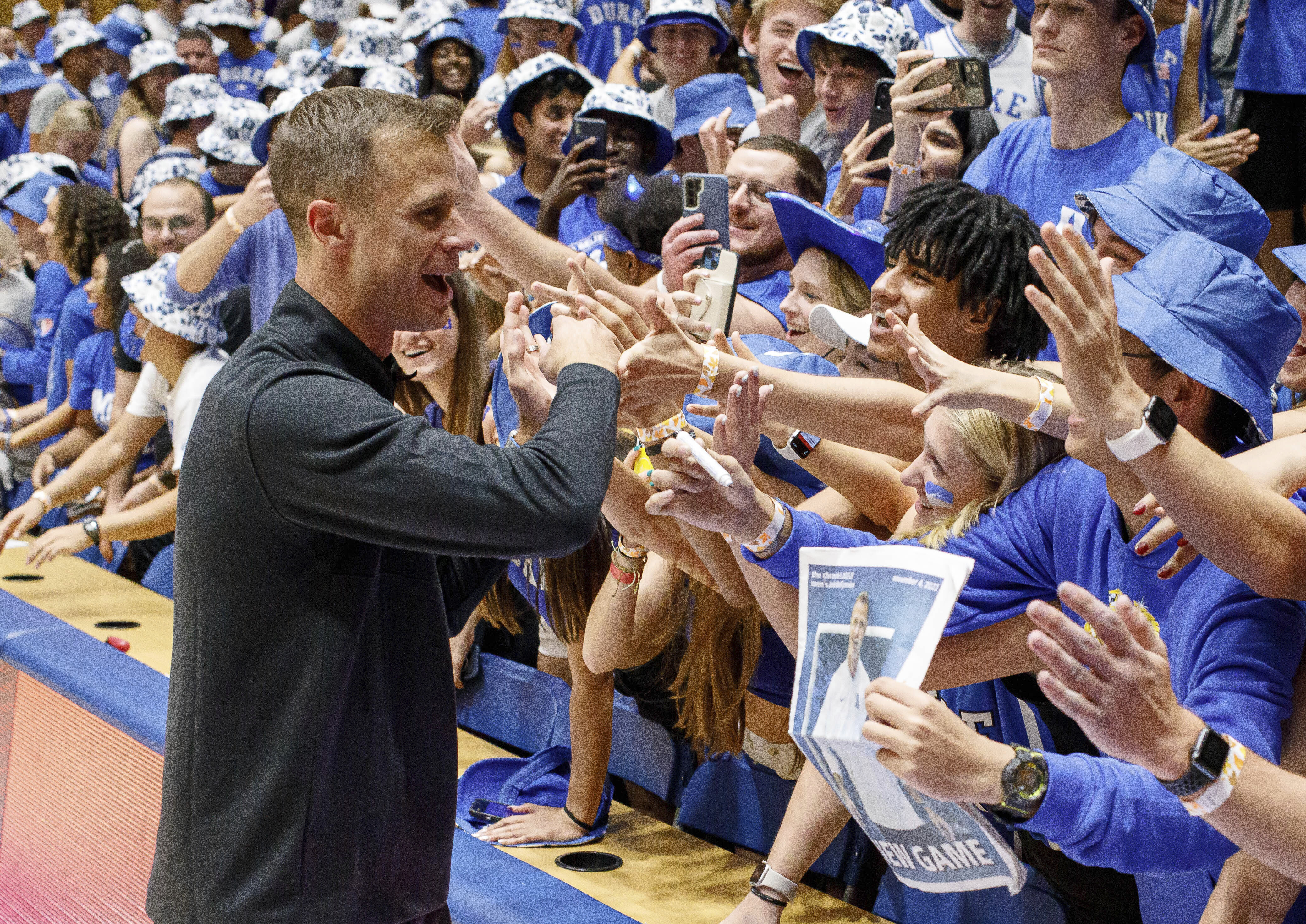 Duke head coach Jon Scheyer greets fans in the Duke student section after earning his first win as head coach of the Blue Devils in an NCAA college basketball game against Jacksonville in Durham, N.C., Monday, Nov. 7, 2022. 