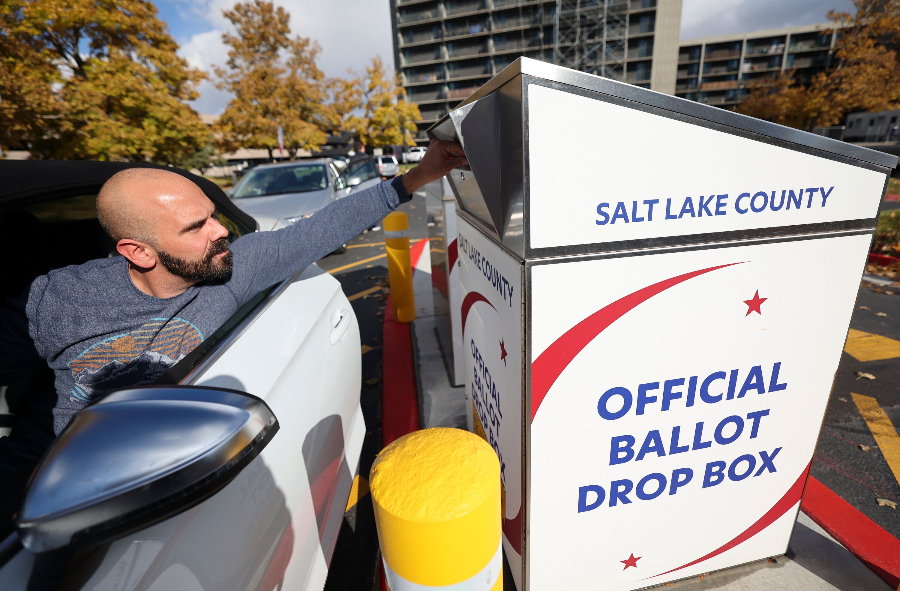 Ritchie Engelhardt drops off his ballot outside of the Salt Lake County Government Center in Salt Lake City on Nov. 3. Nationally, 2022 turnout is tracking high for a midterm — but some states, including Utah, are so far trending low.