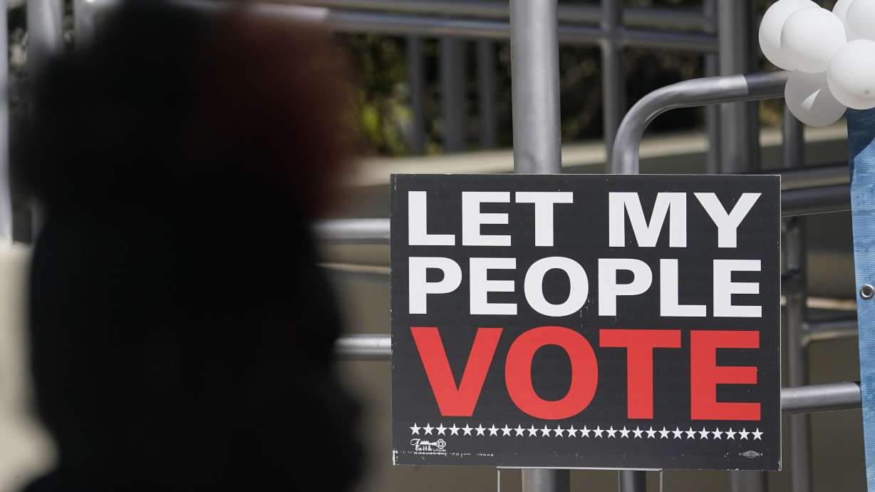 A woman attends an event for Democratic candidate for Florida governor Charlie Crist at an early voting location, Sunday, in Miami.