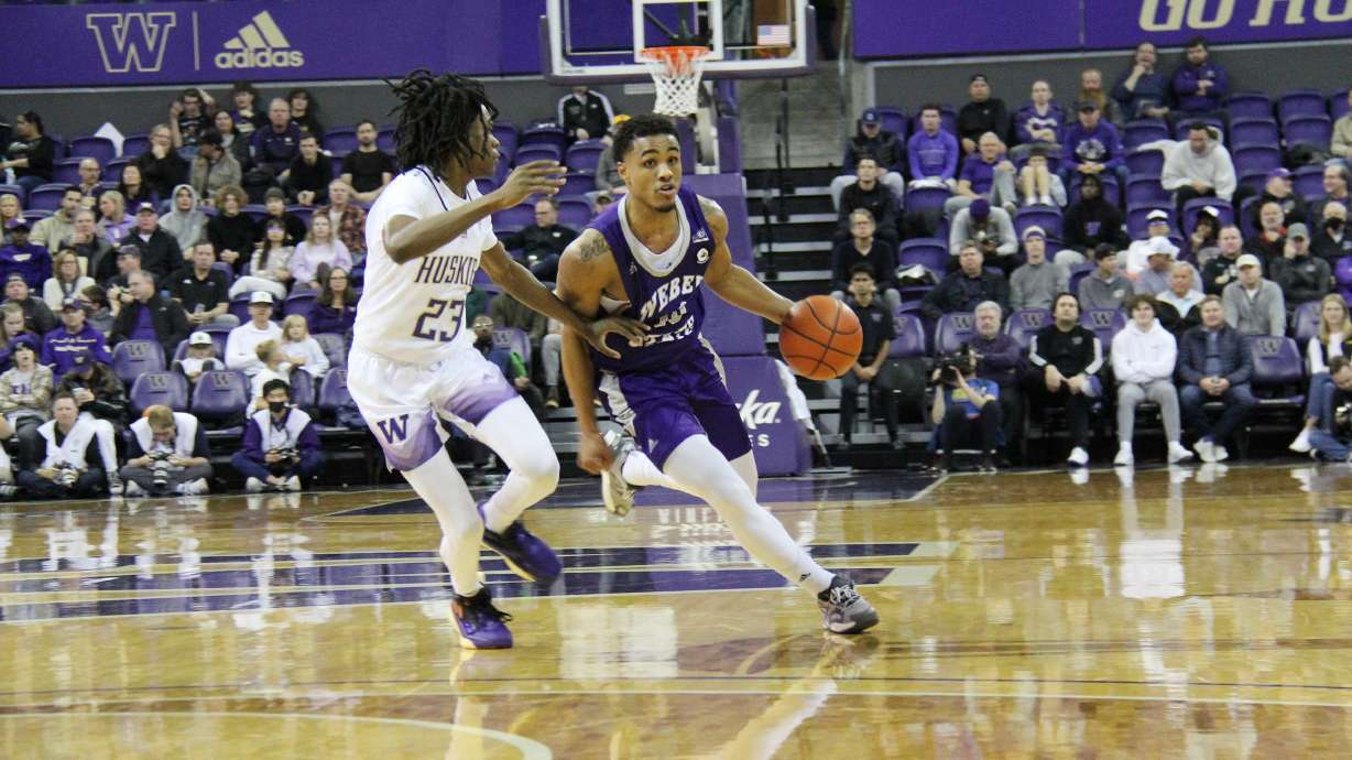 Weber State guard Keith Dinwiddie Jr. drives in against a Washington defender in the season opener on Nov. 7, 2022.