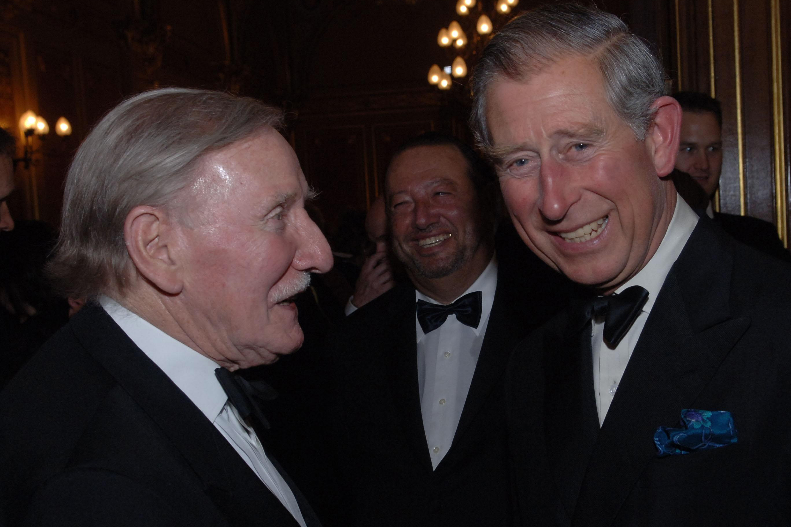 Britain's Prince Charles chats with actor Leslie Philips in London, on May 17, 2006. Leslie Phillips, the British actor best known as the voice of the Sorting Hat in the “Harry Potter” movies, has died. He was 98.