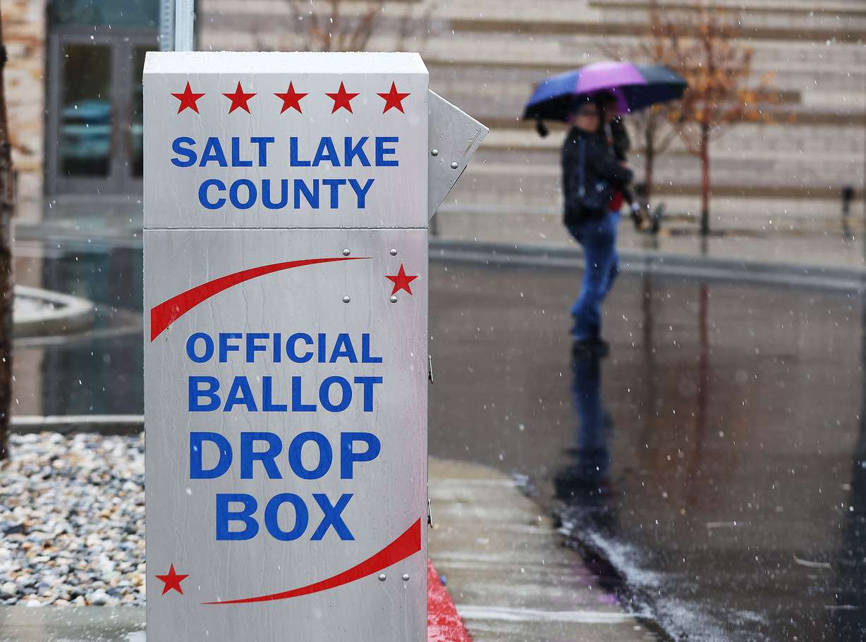 A voter walks past a ballot box on Election Day at city hall in Cottonwood Heights on Tuesday.
