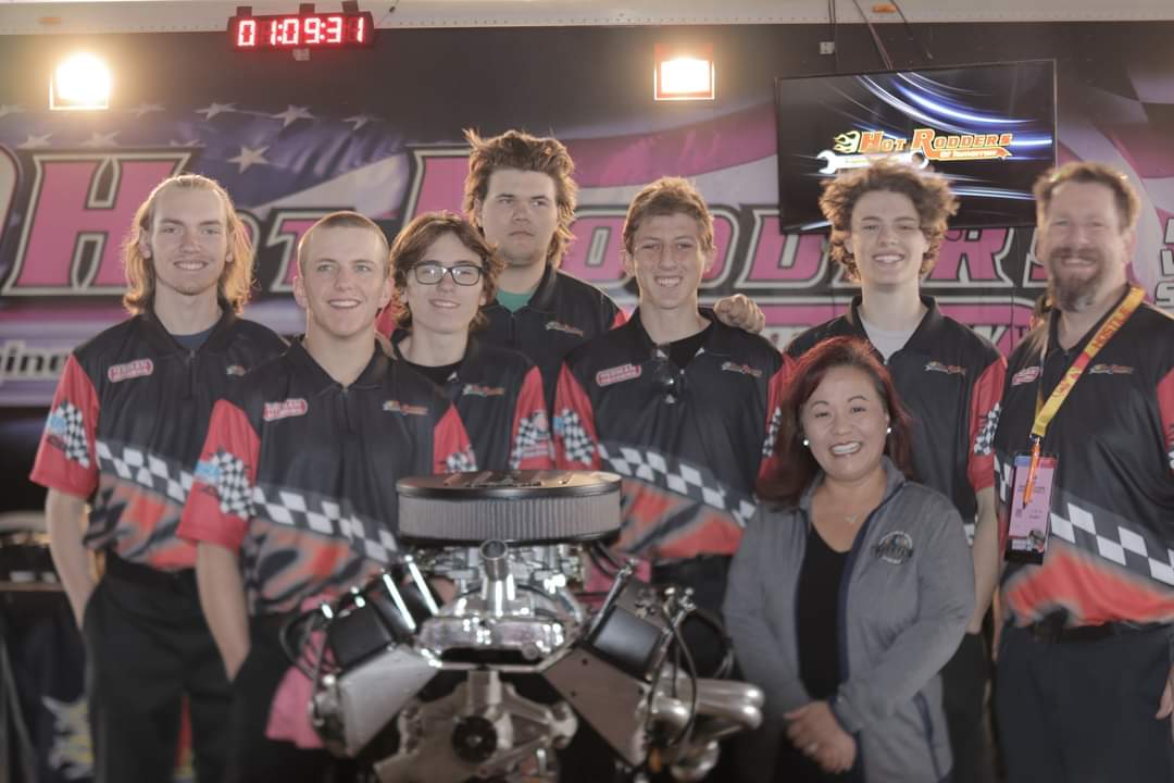 Jacob Fluckiger, Kaden Astle, Lincoln Henderson, Coby Sandberg, Isaac Kobbeman, Nolan Brauer, instructor Adam Arndt and State CTE Specialist Kristina Yamada celebrate Bonneville High School's recent auto shop program award.