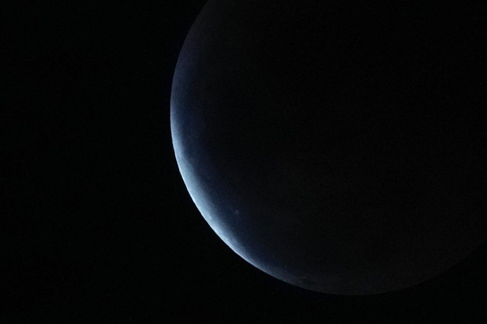 The earth's shadow covers the moon during a lunar eclipse in Metro Manila, Philippines, Tuesday.