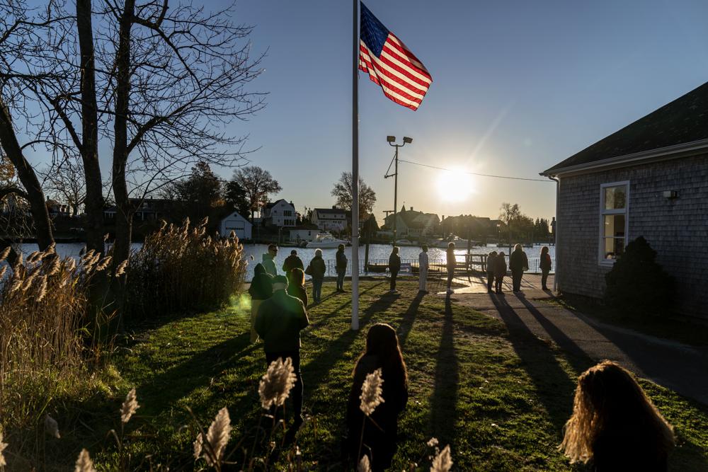 Voters line up to cast their ballots in the midterm election at the Aspray Boat House in Warwick, R.I., Tuesday.