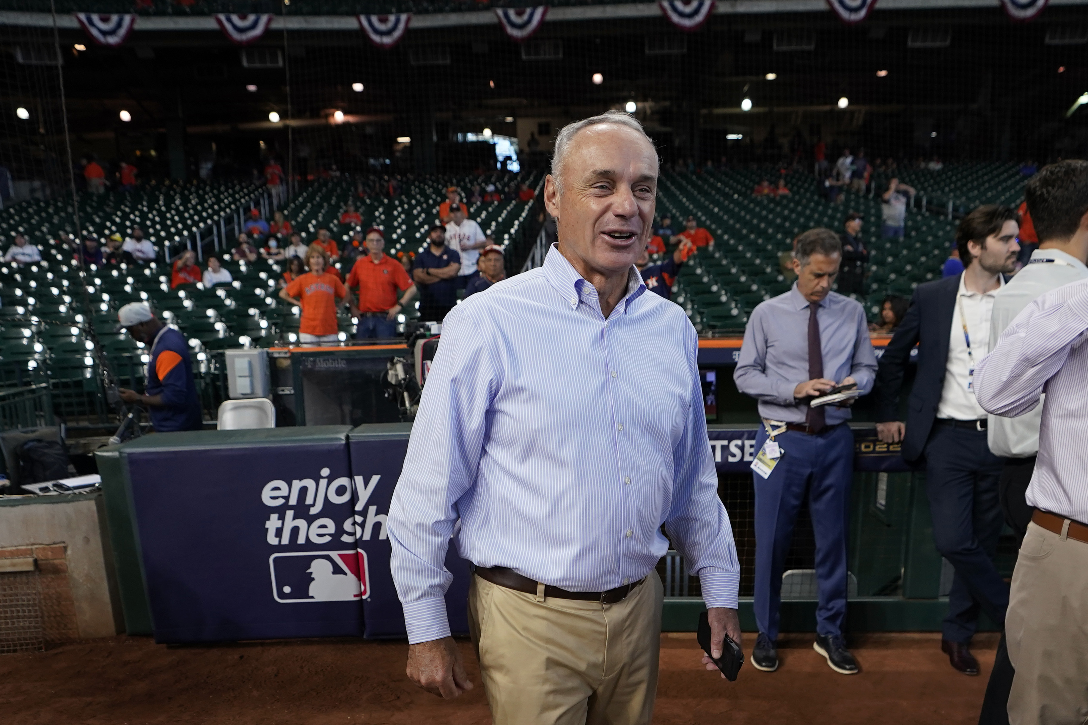 Major League Baseball Commissioner Rob Manfred walks on the field before Game 2 of an American League Division Series baseball game between the Houston Astros and the Seattle Mariners in Houston, Thursday, Oct. 13, 2022. 