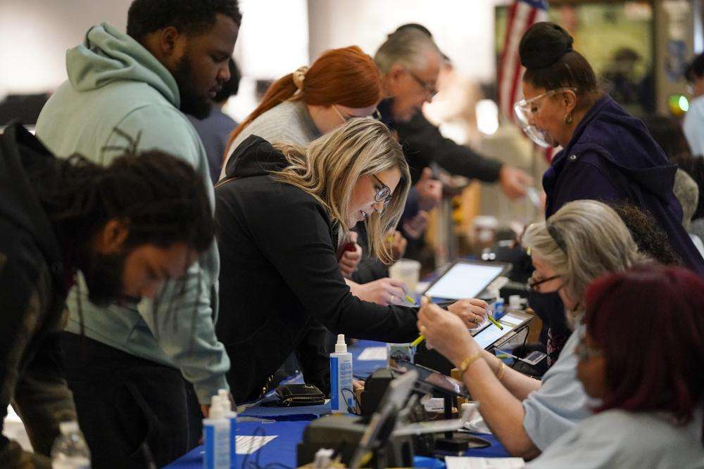 People check in to cast their votes at a polling station in a mall Tuesday in Las Vegas.
