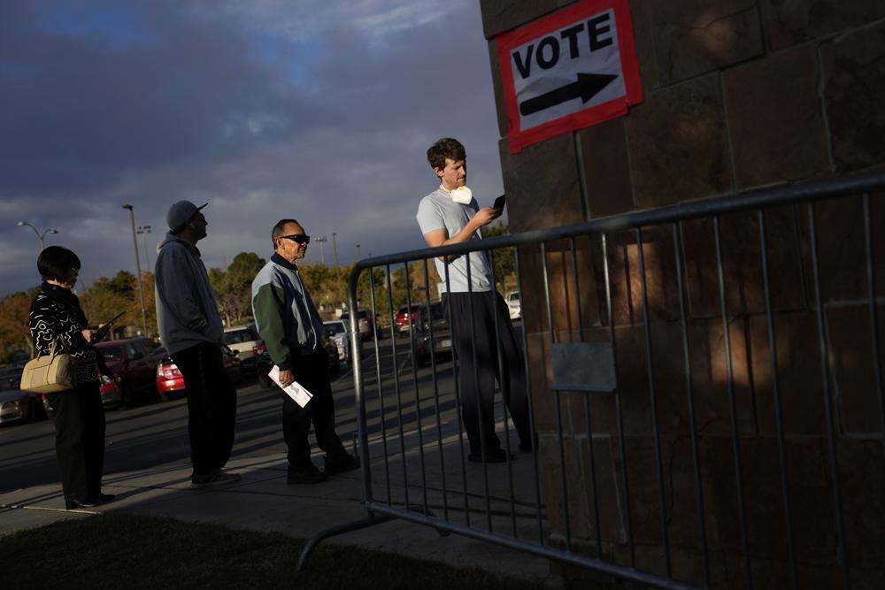 People wait in line to vote at a polling place Tuesday in Las Vegas.