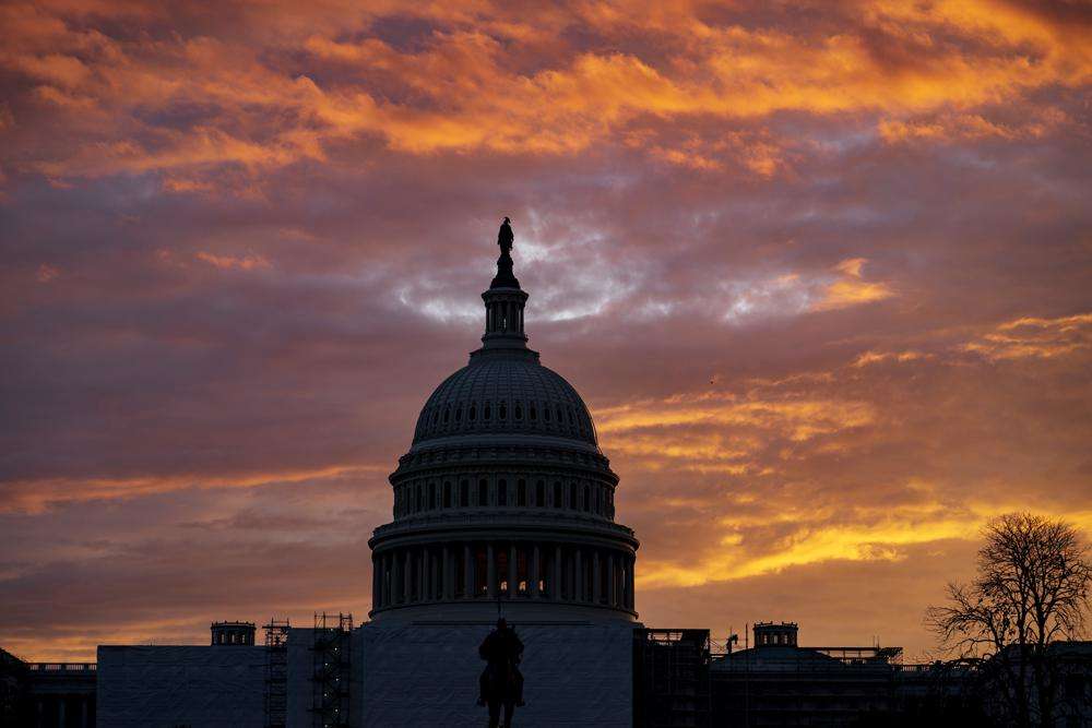 Hues of red and blue color the dawn at the Capitol in Washington, Monday. Control of Congress and of President Joe Biden's agenda on Capitol Hill are at stake this Election Day. Energized Republicans are working to claw back power in the House and Senate and end the Democratic Party's hold on Washington.