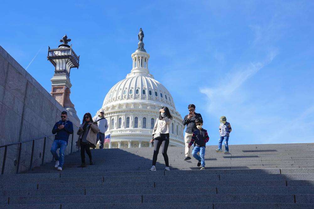 With the U.S Capitol in the background, people walk down steps on Election Day in Washington, Tuesday.