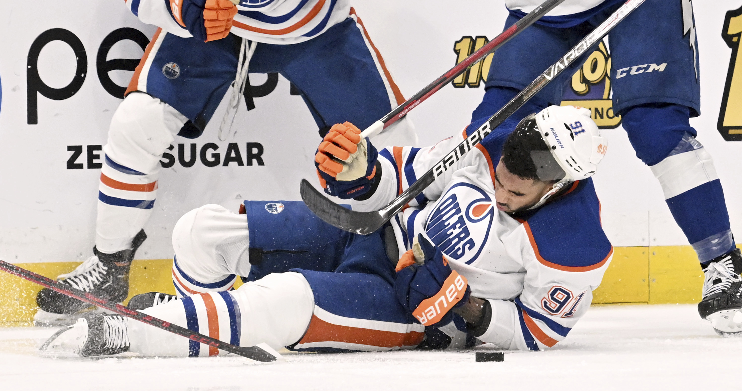 Edmonton Oilers left wing Evander Kane (91) is knocked to the ice during the second period of an NHL hockey game against the Tampa Bay Lightning Tuesday, Nov. 8, 2022, in Tampa, Fla. Kane would leave the ice after being cut on the play. 