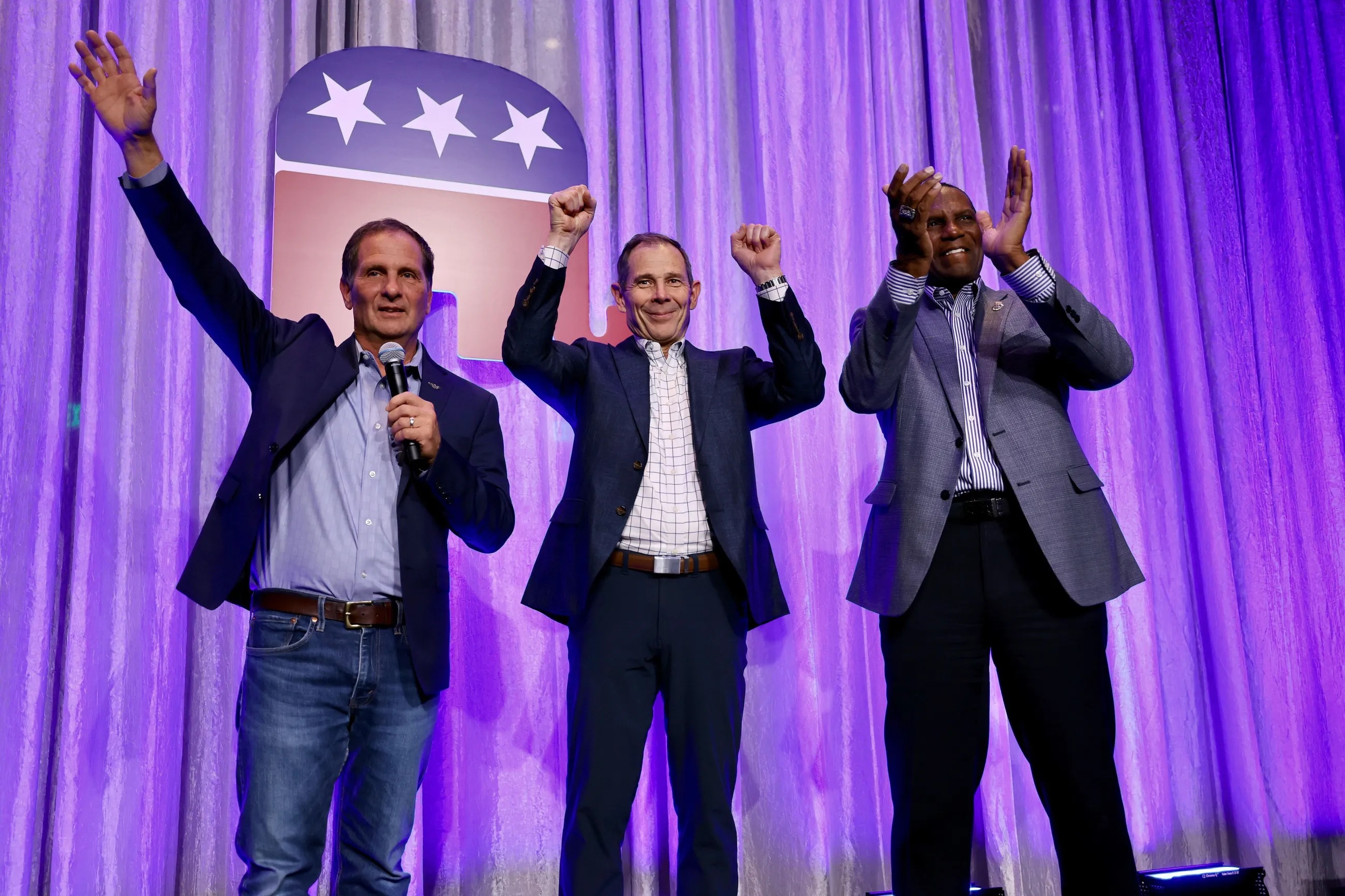 Rep. John Curtis R-Utah, Rep. Chris Stewart, R-Utah and Rep. Burgess Owens R-Utah, take the stage at an election party at the Hyatt Regency in Salt Lake City on Tuesday.