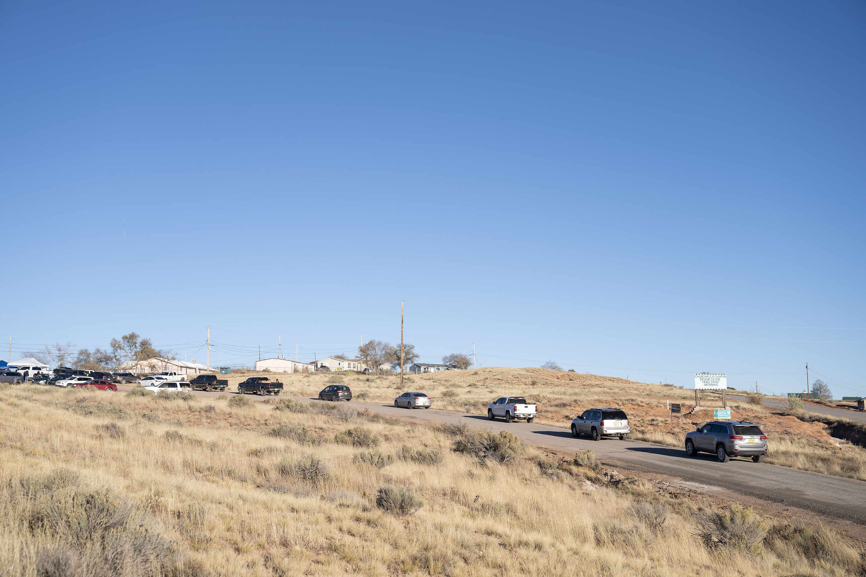A line of cars forms at the Churchrock Chapter House in Church Rock, N.M., as voters arrive to place their ballots Tuesday.