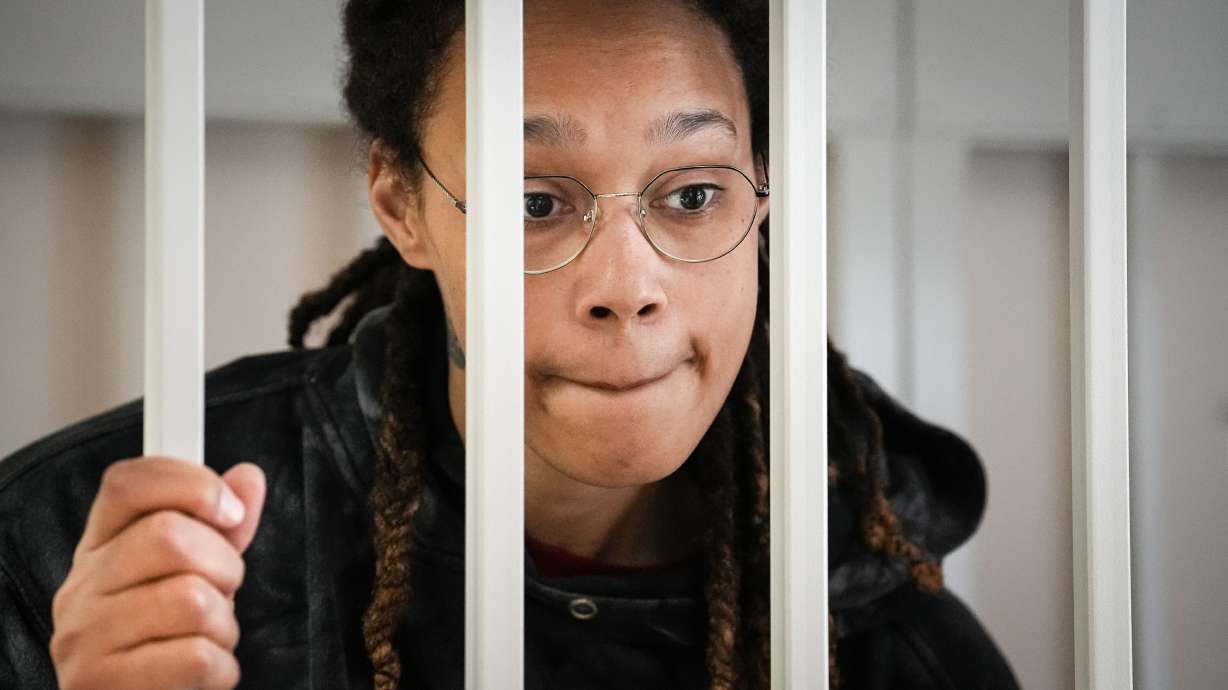 WNBA star and two-time Olympic gold medalist Brittney Griner speaks to her lawyers standing in a cage at a courtroom prior to a hearing, in Khimki just outside Moscow, Russia, July 26. A Russian court has on Oct. 23 started hearing American basketball star Brittney Griner's appeal against her nine-year prison sentence for drug possession.