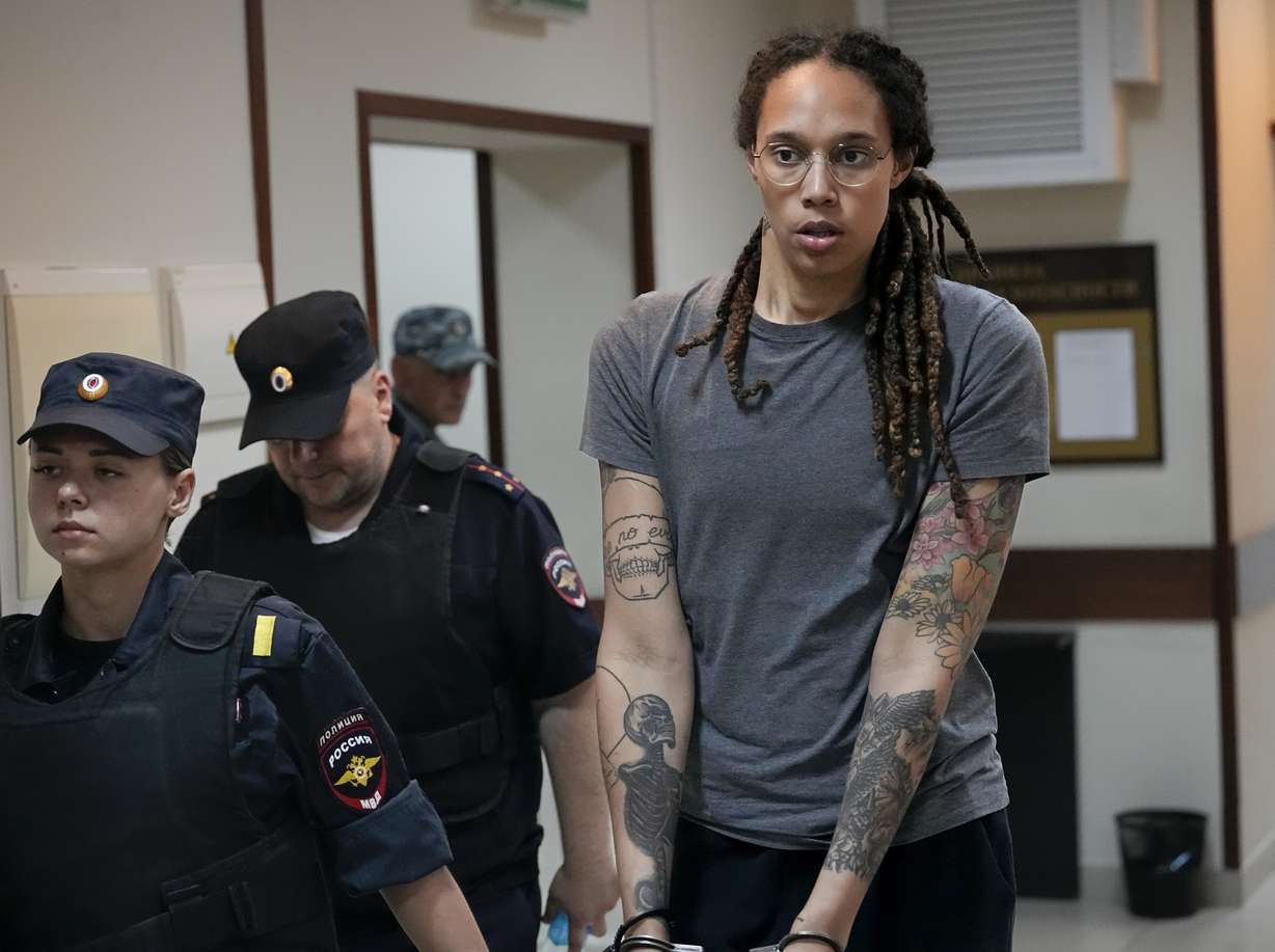 WNBA star and two-time Olympic gold medalist Brittney Griner is escorted from a courtroom after a hearing in Khimki just outside Moscow, Russia, on Aug. 4. The jailed American basketball star has been moved to a penal colony in Russia, her legal team said Wednesday.