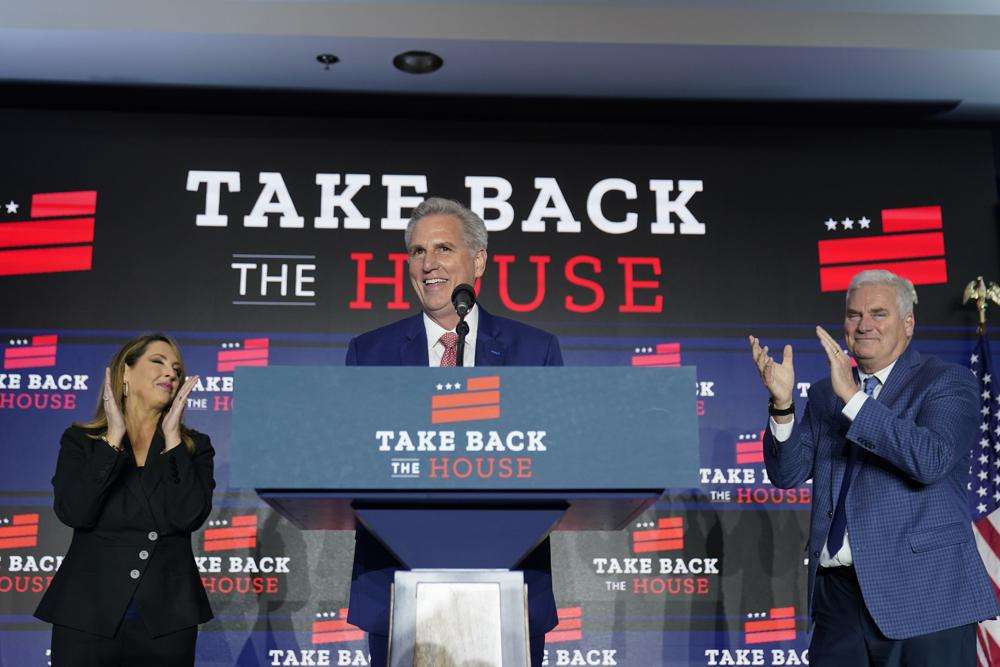 House Minority Leader Kevin McCarthy of Calif., speaks at an election event, early Wednesday, in Washington, as Republican National Committee chair Ronna McDaniel, left, and Rep. Tom Emmer, R-Minn., listen.