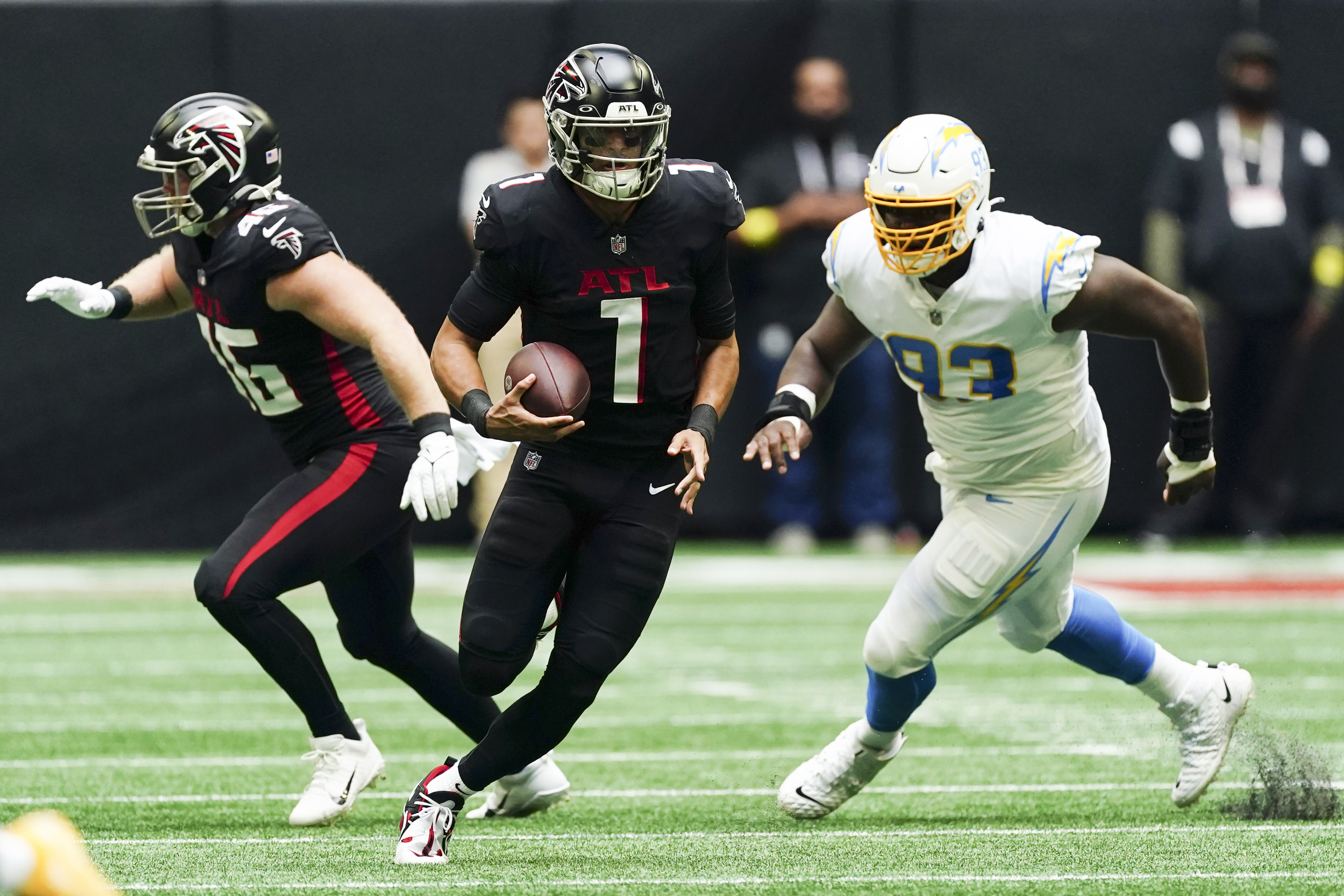 Atlanta Falcons quarterback Marcus Mariota (1) scrambles up field ahead of Los Angeles Chargers defensive tackle Otito Ogbonnia (93) during the first half of an NFL football game, Sunday, Nov. 6, 2022, in Atlanta. 