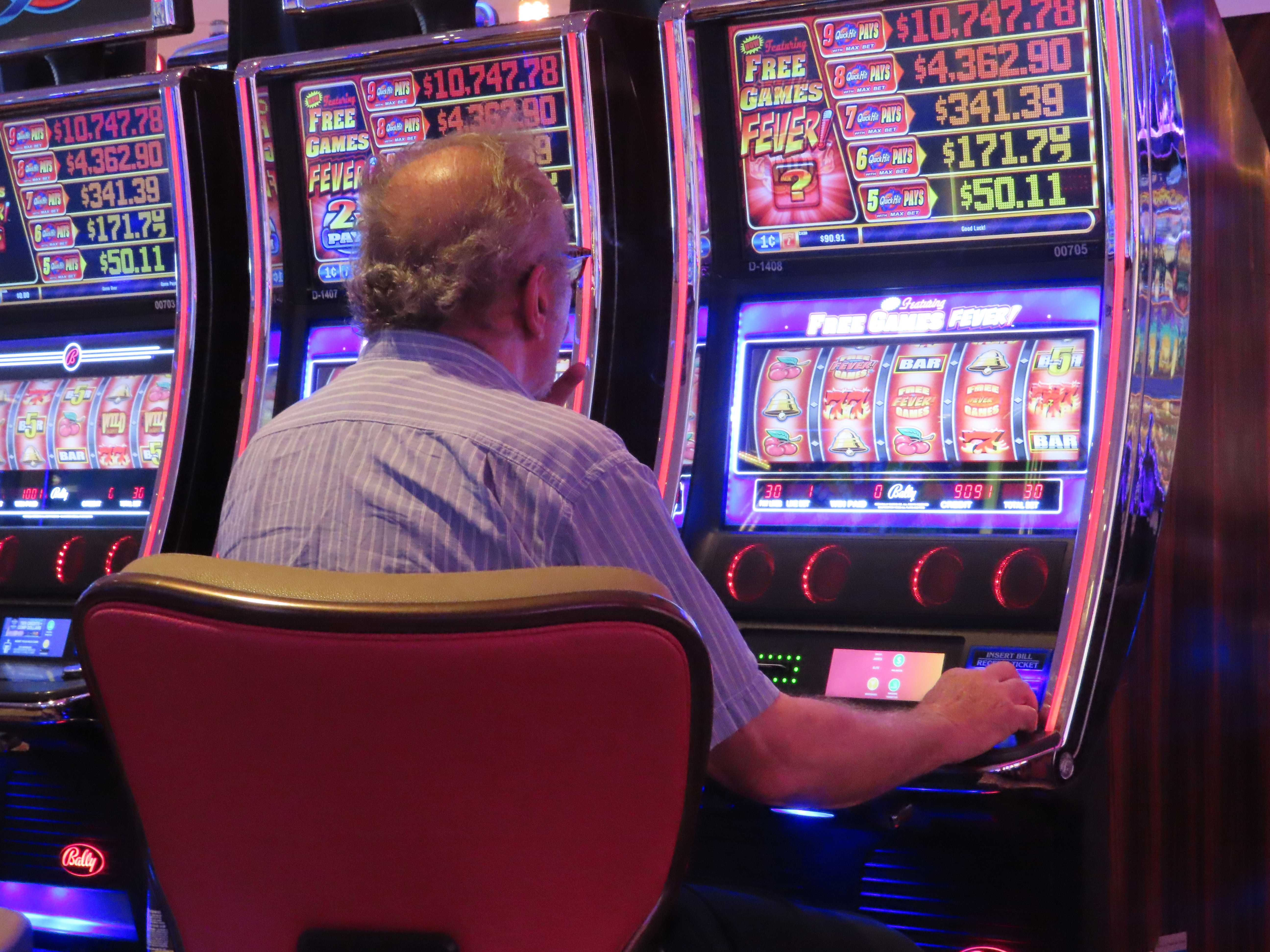 A gambler plays a slot machine at the Hard Rock Casino in Atlantic City, N.J., on Aug. 8, 2022. Figures released on Nov. 9, 2022, by the American Gaming Association show the U.S. commercial casino industry had its best quarter ever, winning over $15 billion from gamblers in the third quarter of this year. 