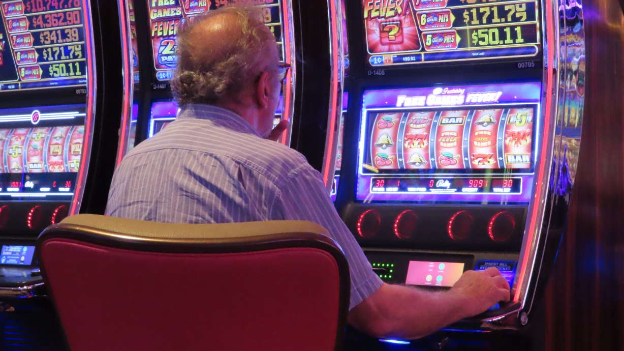 A gambler plays a slot machine at the Hard Rock Casino in Atlantic City, N.J., on Aug. 8, 2022. Figures released on Nov. 9, 2022, by the American Gaming Association show the U.S. commercial casino industry had its best quarter ever, winning over $15 billion from gamblers in the third quarter of this year.