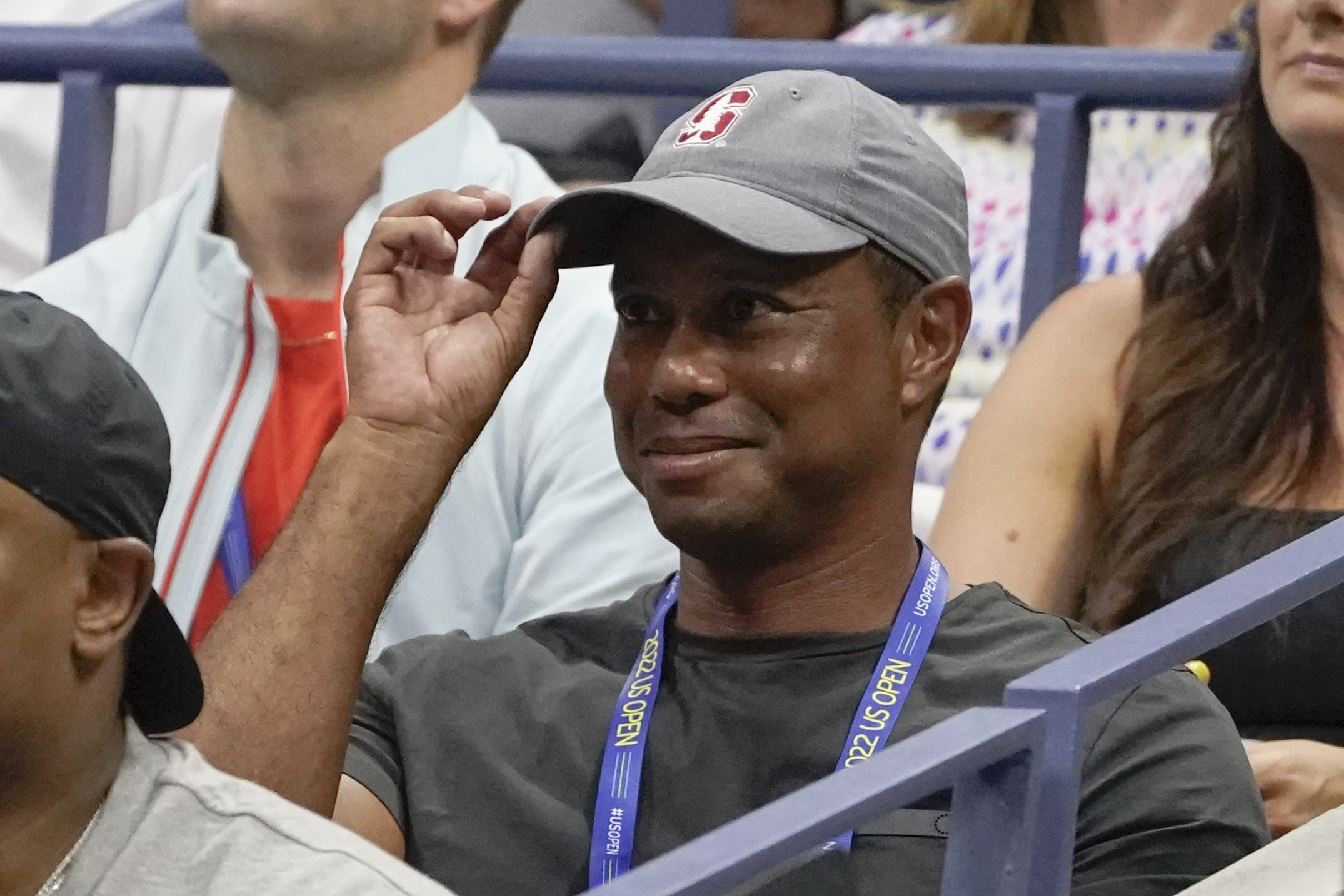 FILE - Tiger Woods tips his hat to the crowd during a match between Serena Williams and Anett Kontaveit, of Estonia, in the second round of the U.S. Open tennis championships, Wednesday, Aug. 31, 2022, in New York. Woods has won the Player Impact Program on the PGA Tour despite playing only three times. He is likely to play three unofficial events in December.