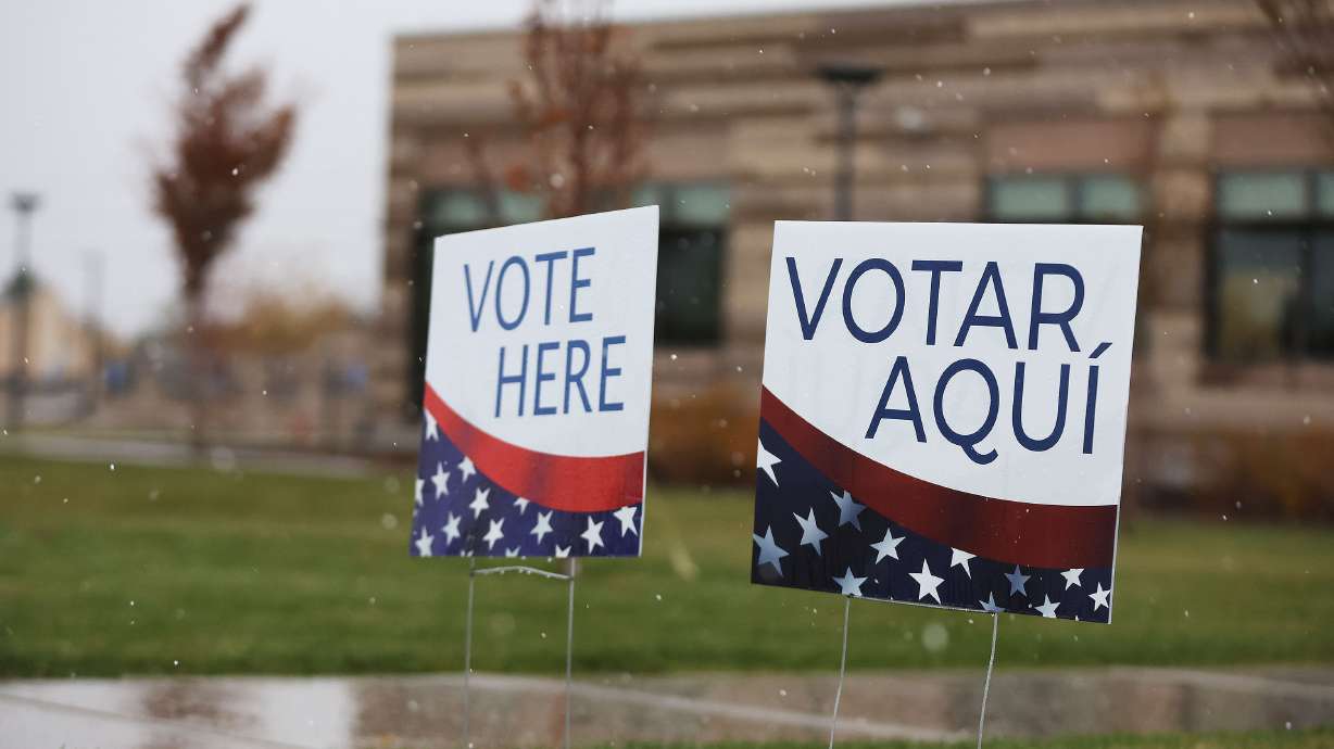 Signs show voters polling locations on Election Day in Cottonwood Heights on Tuesday. Several counties updated their election results again Wednesday evening.