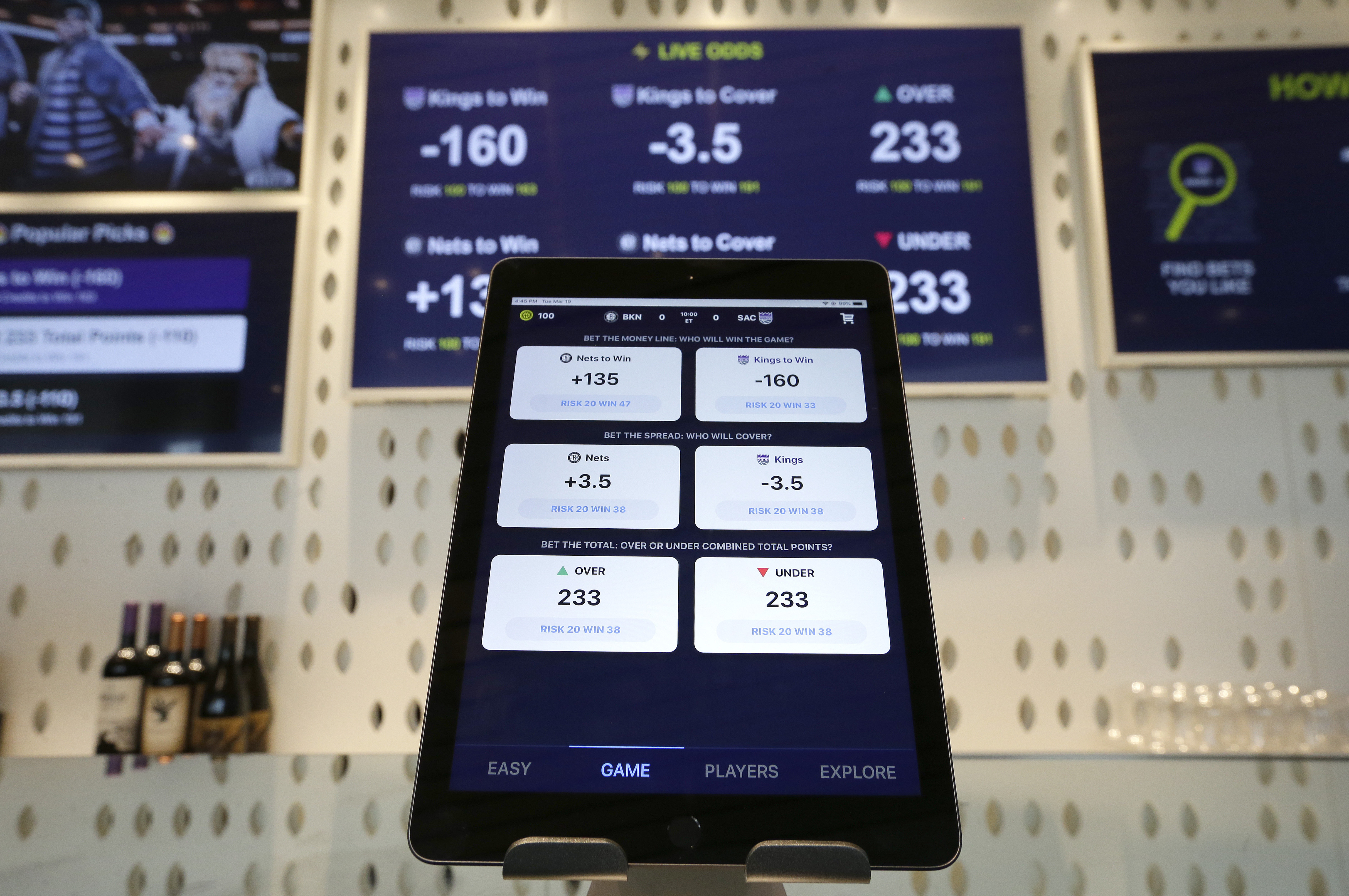 FILE - An iPad displays the types of free bets that could be placed at the Golden 1 Center's Skyloft Predictive Gaming Lounge in Sacramento, Calif., March 19, 2019. The campaign that could bring legalized sports betting to California has become the most expensive ballot initiative fight in state history. Two rival proposals are pitting wealthy Native American tribes against FanDuel, DraftKings and other online gambling companies, in a contest over what could become the nation's most lucrative marketplace. 