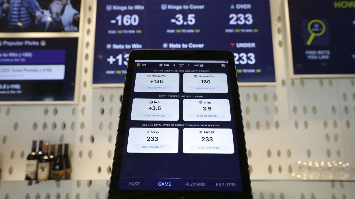 FILE - An iPad displays the types of free bets that could be placed at the Golden 1 Center's Skyloft Predictive Gaming Lounge in Sacramento, Calif., March 19, 2019. The campaign that could bring legalized sports betting to California has become the most expensive ballot initiative fight in state history. Two rival proposals are pitting wealthy Native American tribes against FanDuel, DraftKings and other online gambling companies, in a contest over what could become the nation's most lucrative marketplace.